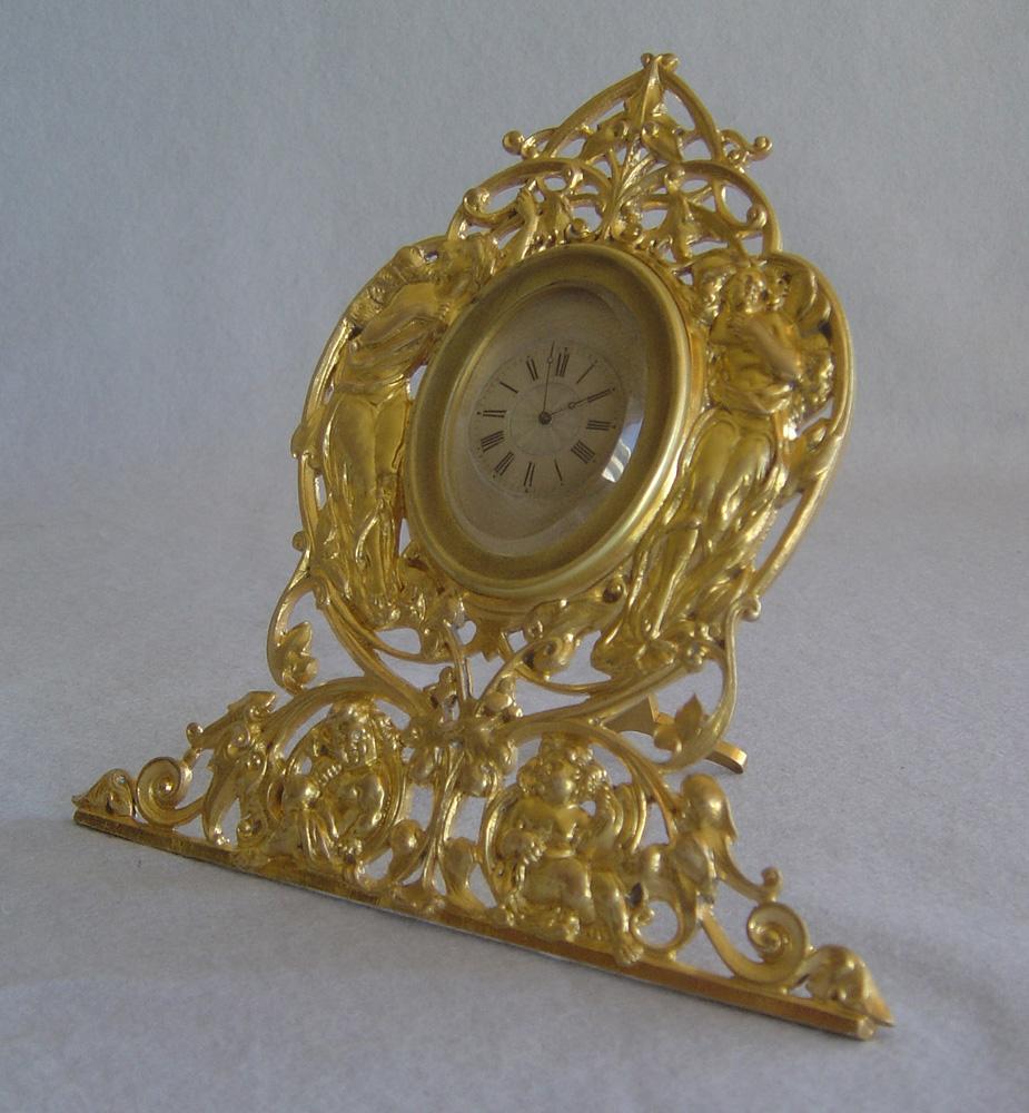 A highly unusual and rare Art Nouveau gilt bronze strut clock in the manner of Cole and Signed 