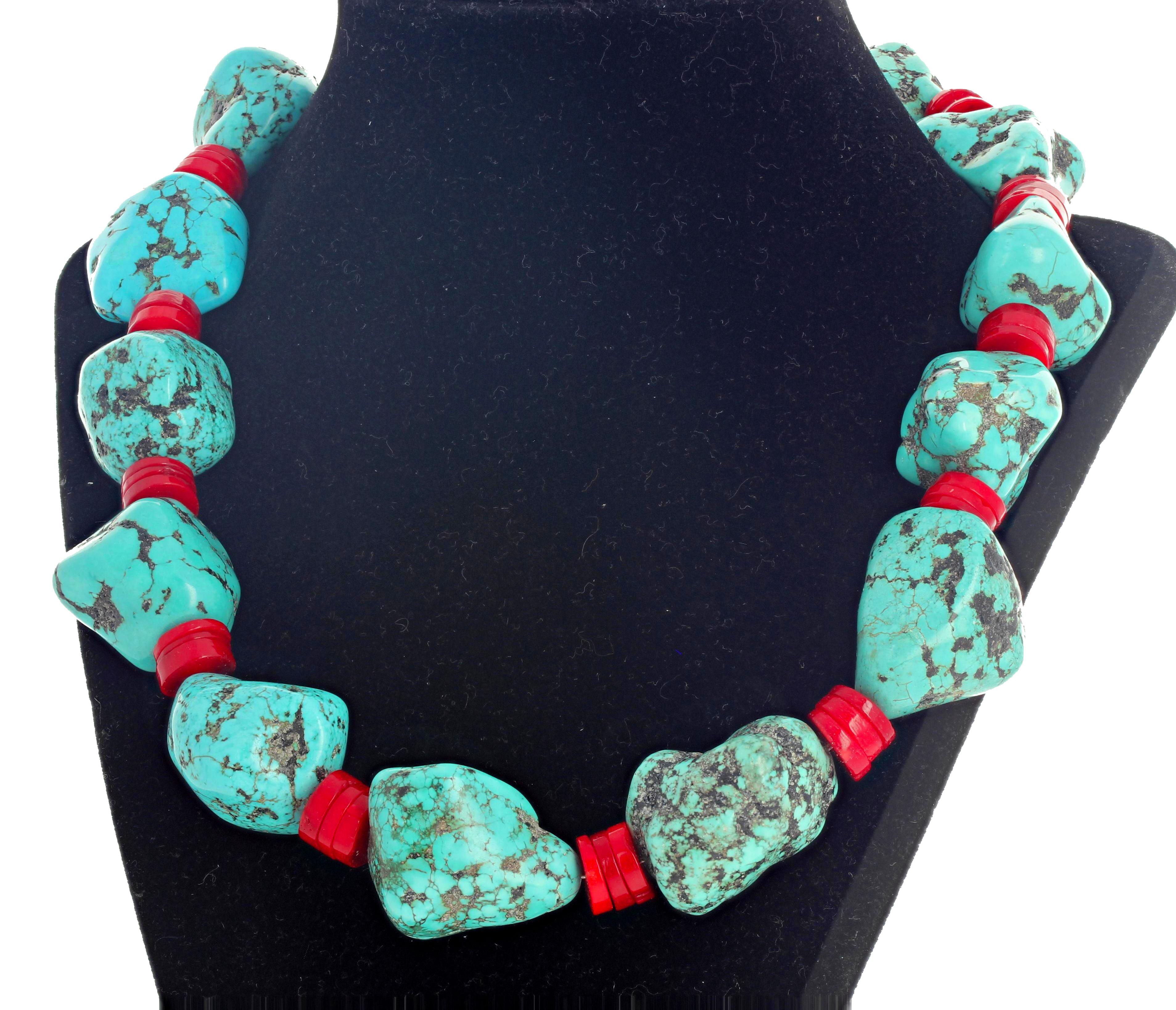 Blue and blue-green Howlite Turquoise (largest approximately 30 mm x 22 mm) enhanced with sliced rondels of natural red Coral set in a 19.5 inch long necklace with silver hook clasp.   If you wish faster delivery on your purchase choose UPS to ship