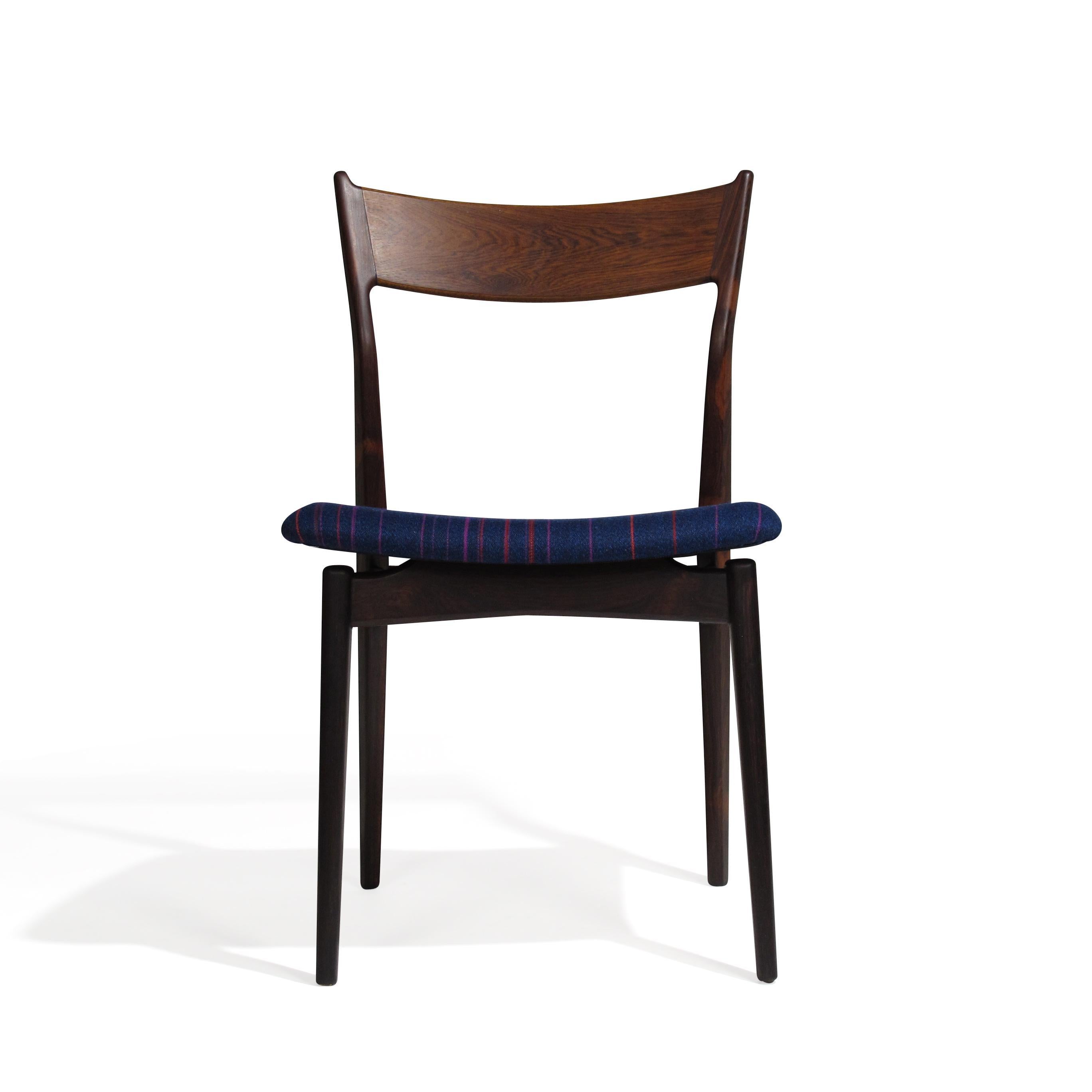 Midcentury Brazilian rosewood dining chairs designed by H.P. Hansen for Randers Mobelfabrik. Handcrafted of solid Brazilian rosewood frames with a sculpted backrest and newly upholstered seats in blue wool textile. The wood used on the frames is of