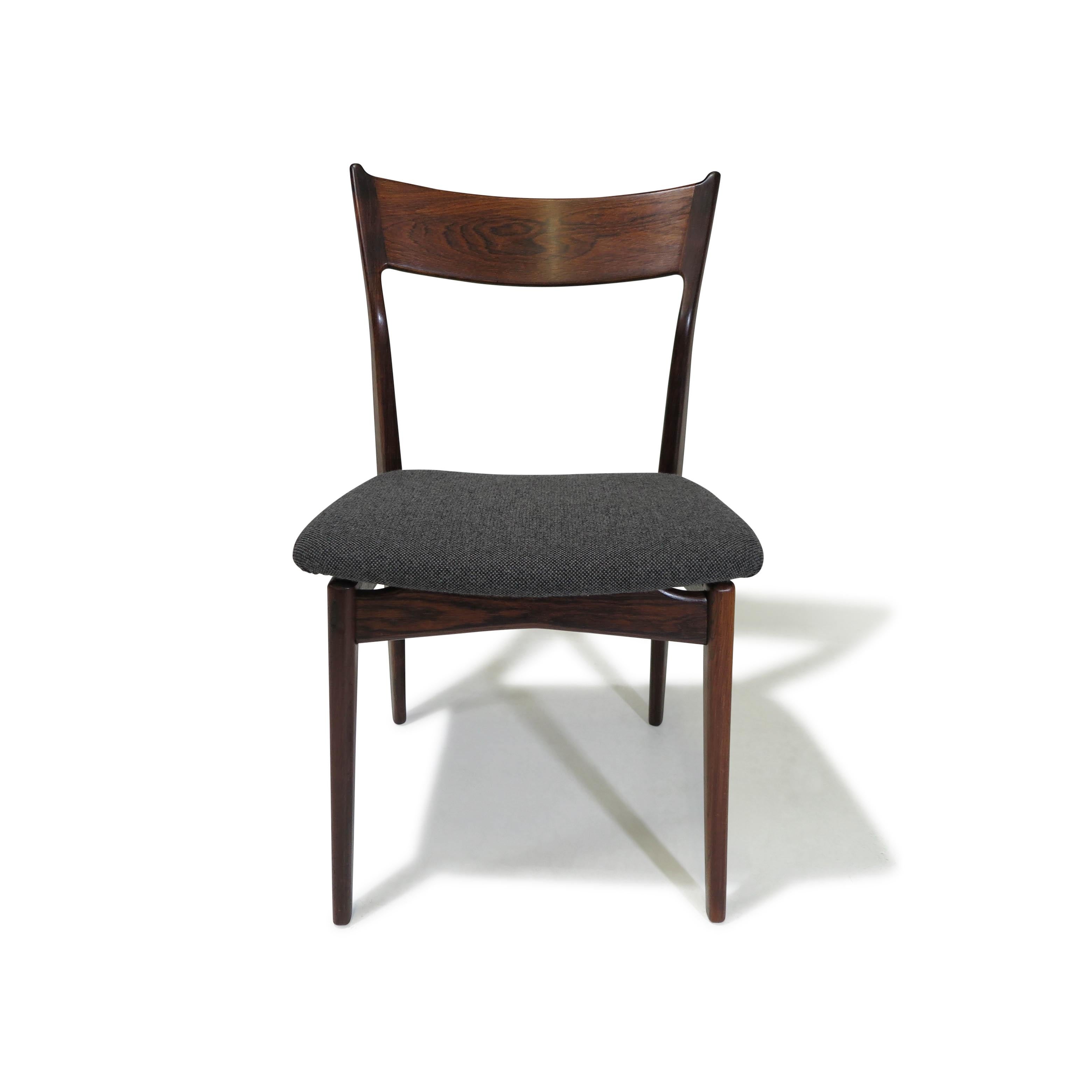 Midcentury Brazilian rosewood dining chairs designed by H.P. Hansen for Randers Møbelfabrik. Handcrafted from solid Brazilian rosewood, these chairs feature sculpted backrests. The frames showcase the finest rosewood, characterized by its dark