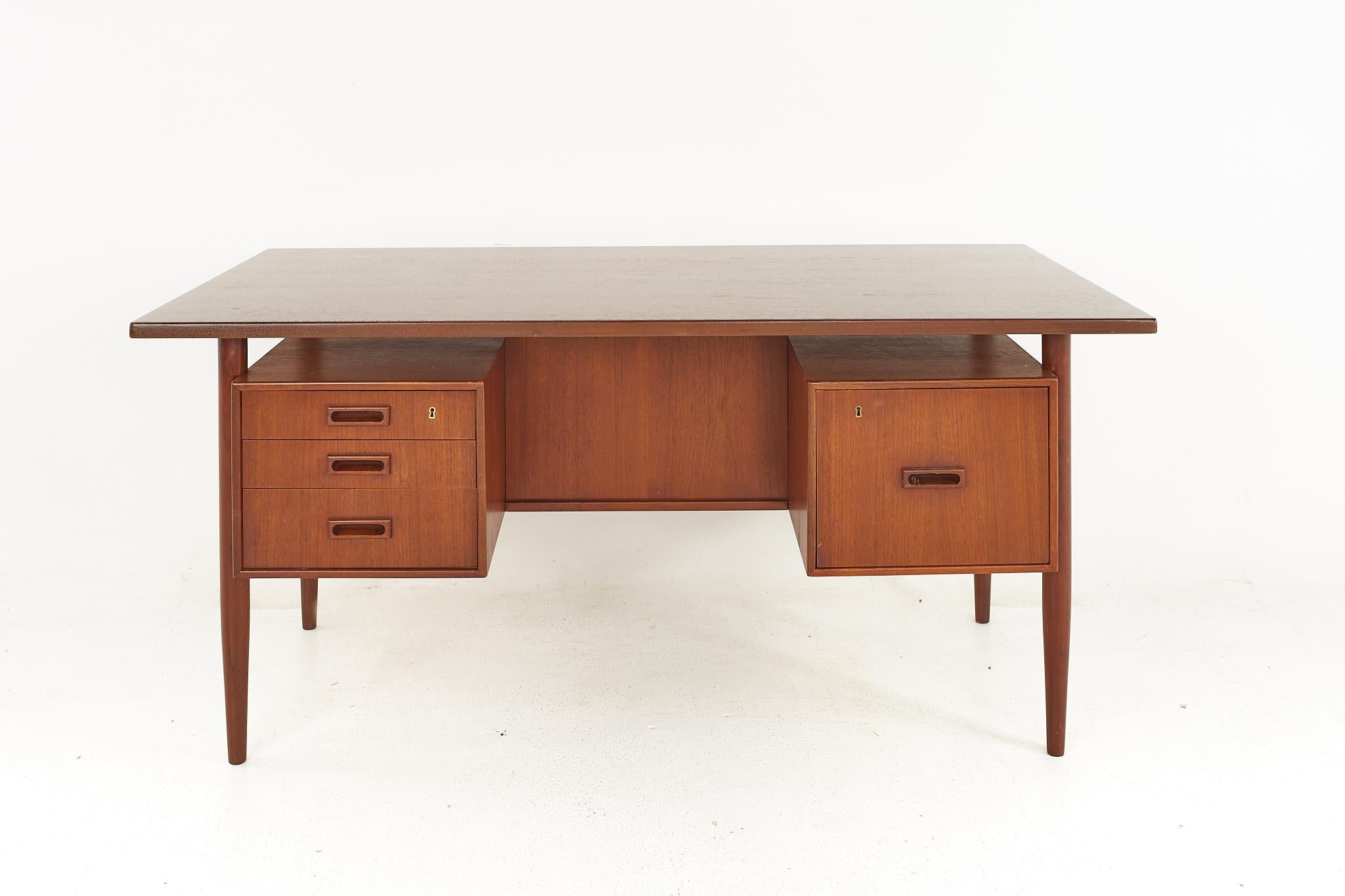 HP Hansen Mid Century Danish Teak Desk

The desk measures: 62.5 wide x 31.5 deep x 29.5 inches high, with a chair clearance of 27.75 inches

Please Note: The second set of photos you see for this piece are what it looked like BEFORE our restoration