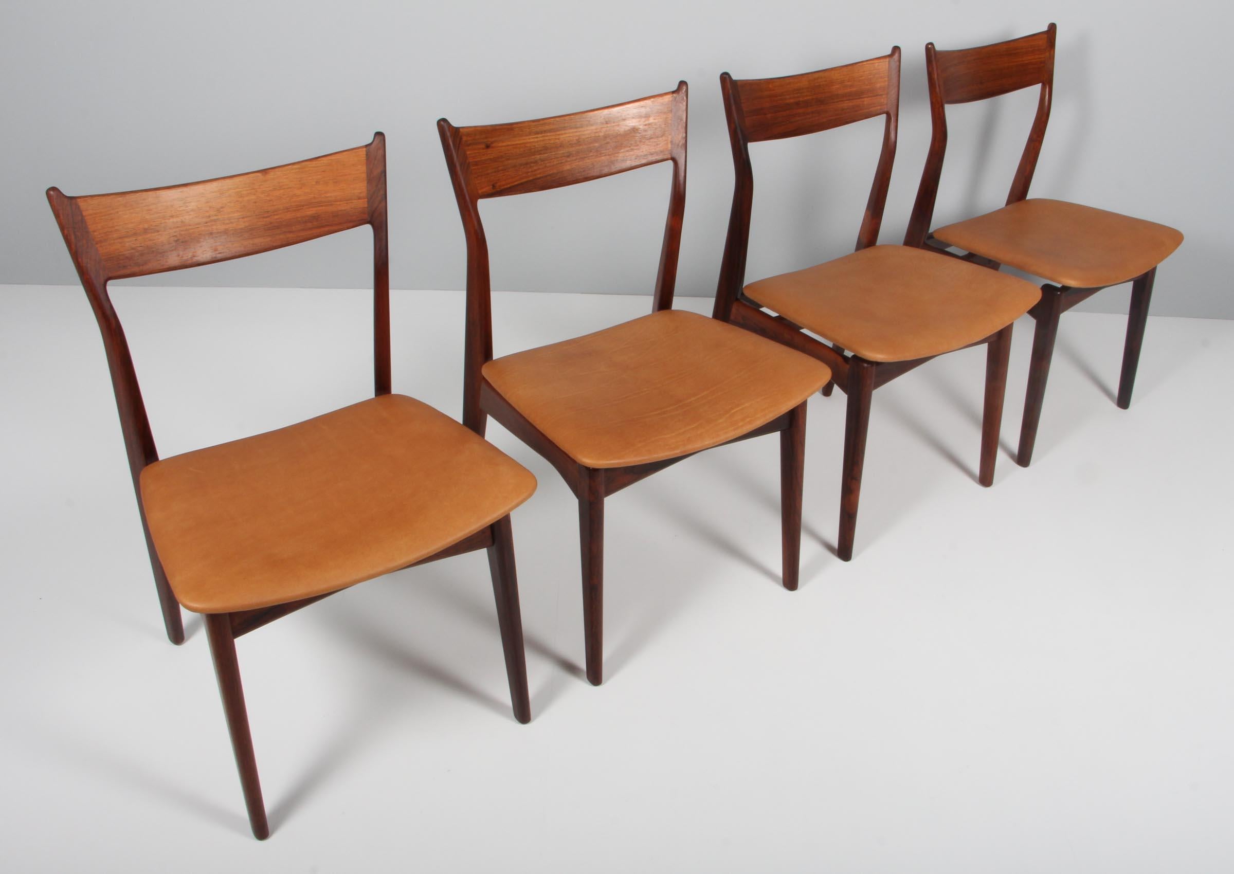 HP Hansen set of four dining chairs new upholstered with aniline leather.

Made in partly solid rosewood.

Made by HP Hansen in Denmark in the 1960s.