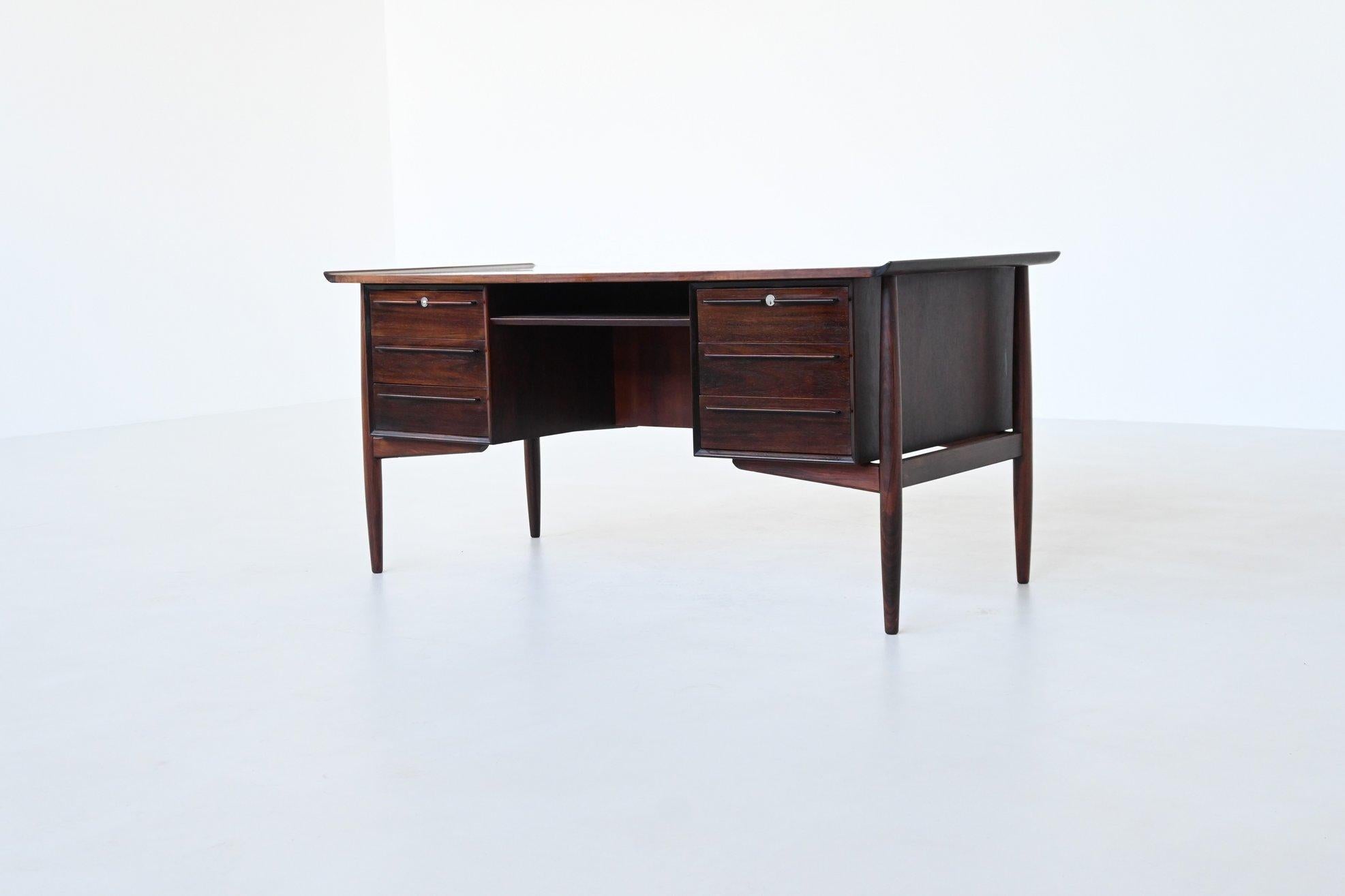 Beautiful writing desk designed by Arne Vodder; one of the best designers Denmark has known and it is manufactured by H.P. Hansen, Denmark 1960. This exquisite symmetric writing desk is a paragon of Danish modern furniture design. Constructed from