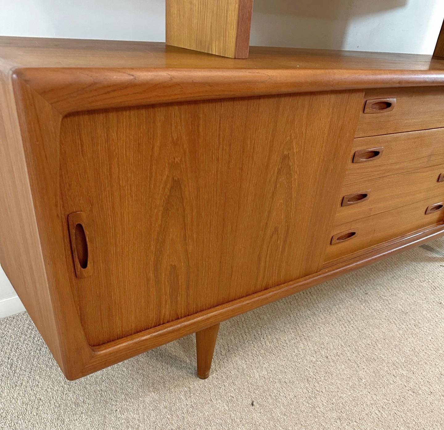 H.P. Hansen Teak Credenza with Hutch, circa 1960s. Scandinavian Style. Danish modern credenza and china display hutch will give you all the storage and display you could want. The hutch has glass sliding doors and sits upon shaped legs that rest