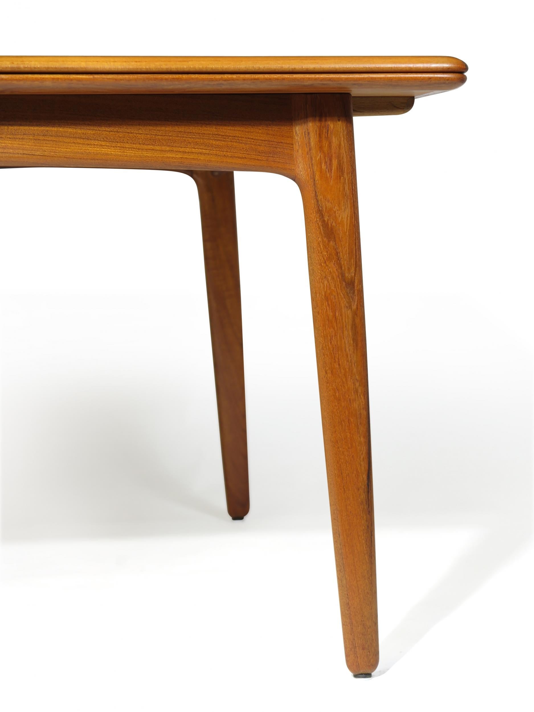 Danish dining table in rich dark teak by HP Hansen, circa 1950s. Beautifully restored, excellent condition and features a draw leaves tucked under the tabletop allow the piece to seat 6-10 guests comfortably.
Fully extended with two leaves opened,