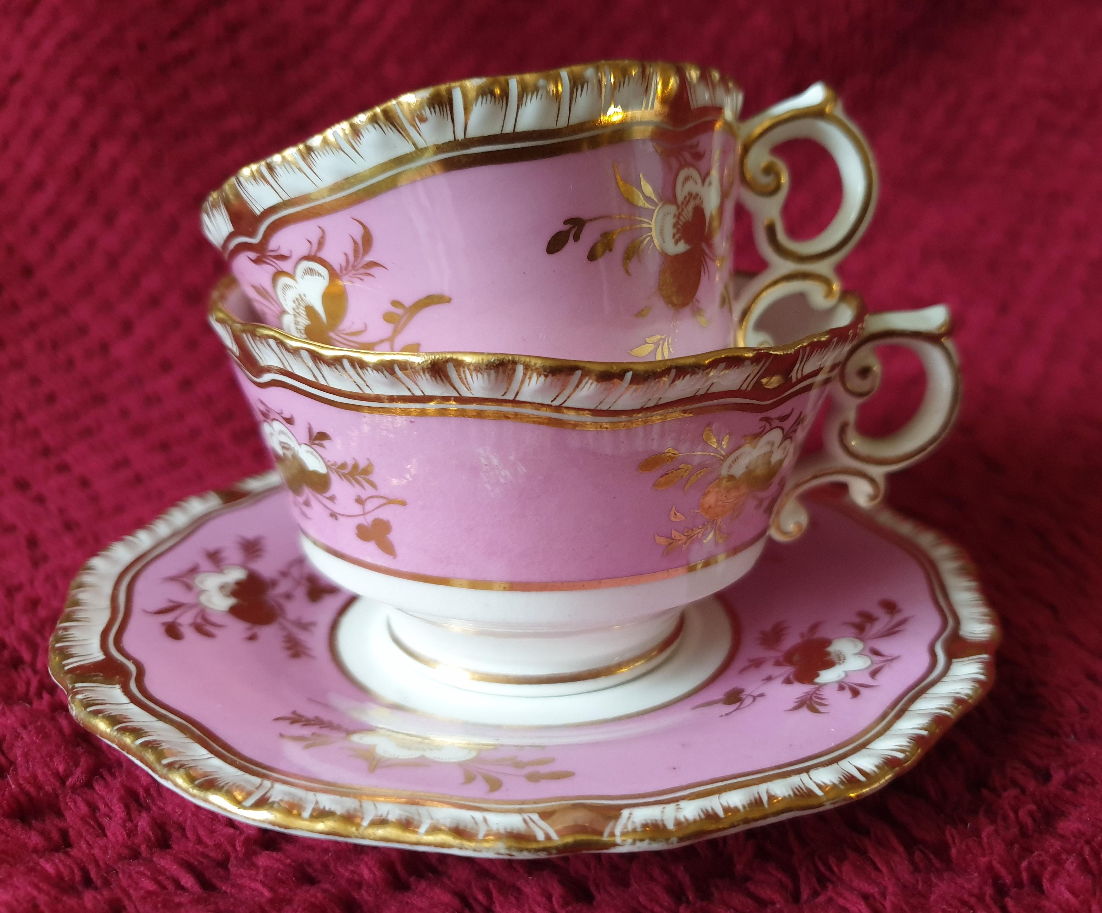 A beautiful pink trio by H&R Daniel with scenes summer flowers. The insides of both coffee and tea cups are vignettes of summer flower all handpainted in a flourish of colours. Heavy gilt in floral designs accentuate the pastel or baby pink ground.