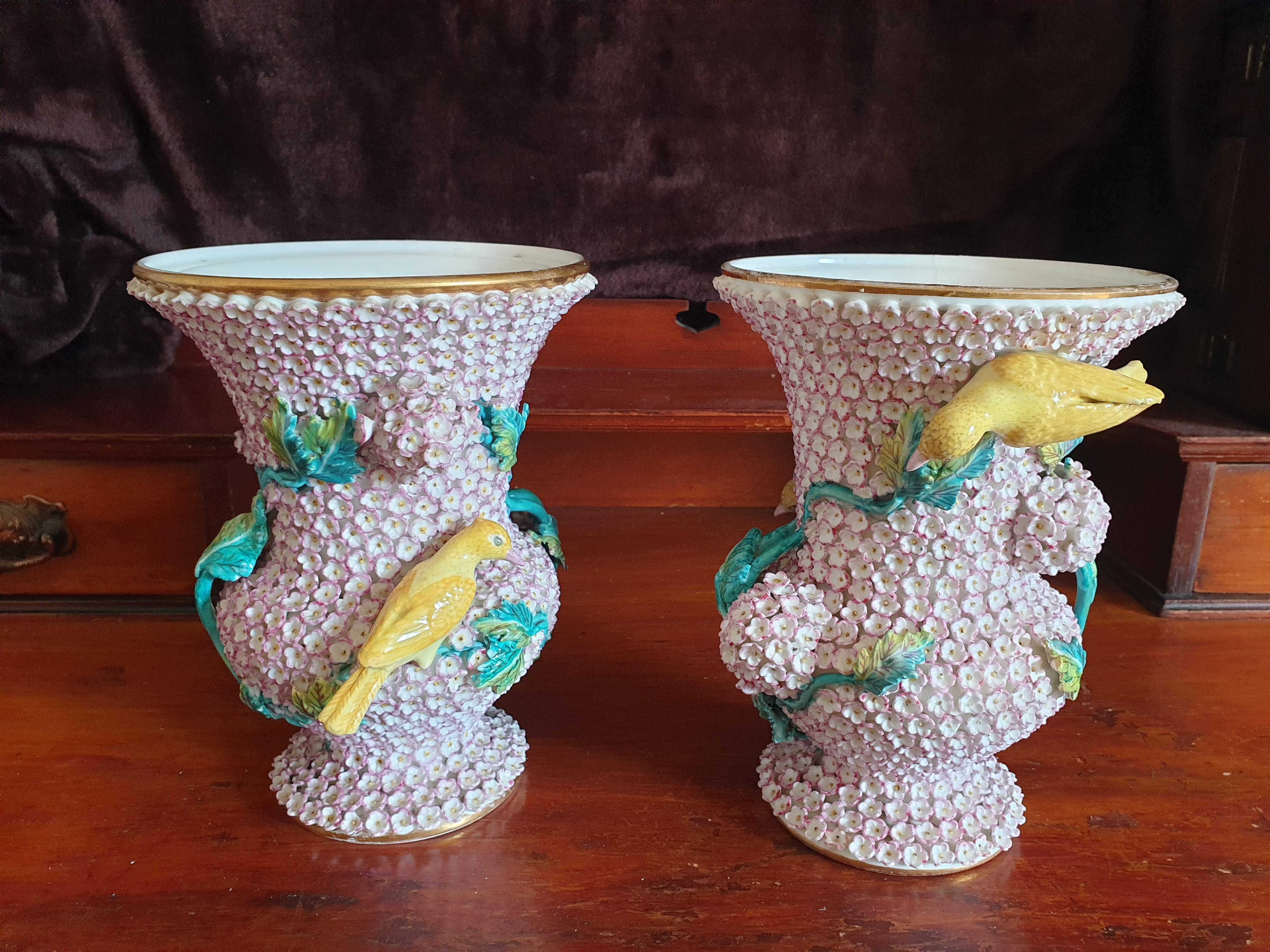 A stunning and extremely rare pair of pink Schneeballen H & R Daniel Campana shape. Lidded vases, decorated with canaries on turquoise vines. In perfect condition dates from 1840's set on 24k gold gilt rims.