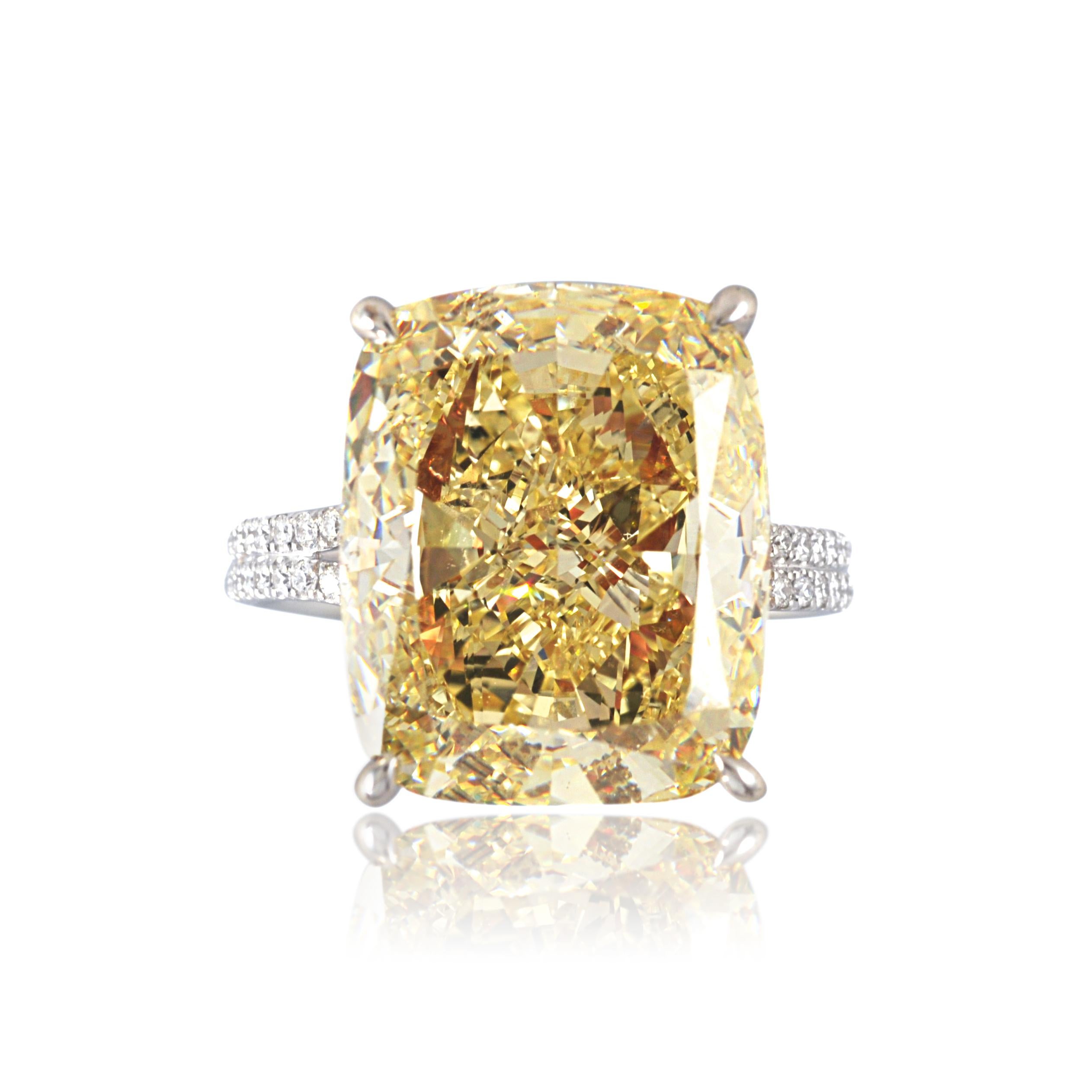 A singular fancy yellow cushion diamond framed by a double row of fancy intense yellow round diamonds, and supported by a diamond set gallery and shank. A piece for the true collector or connoisseur.
HRD Certified Fancy Yellow Cushion Diamond 11.07