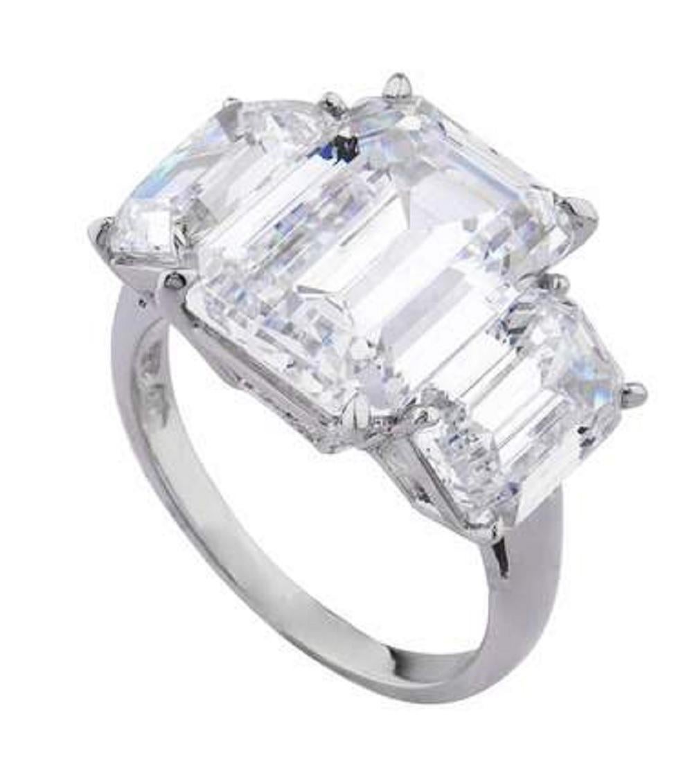 Magnificent engagement ring crafted in platinum, featuring a spectacular  HRD certified emerald cut diamond weighing 5.05 carats, I color, VVS1 clarity, adorned with two carefully selected and perfectly matched emerald cut diamonds both certified by