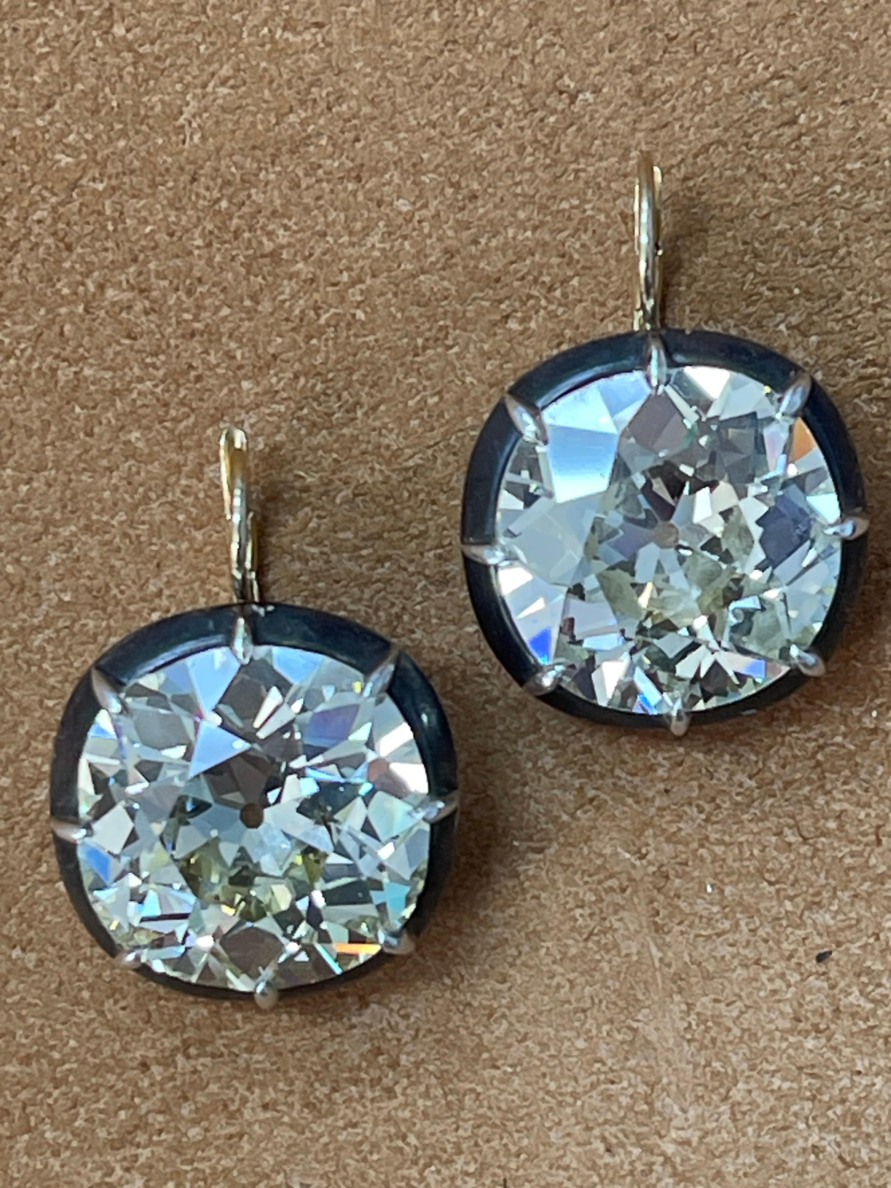 Breathtaking beauty !! 
An exquisite and unique pair of old cut diamond earrings weighing a total of 53.41 carats. 

The details are as follows : 

Diamond weight : 28.27 carat 
Color : OP color 
Clarity : SI1
Measurements : 19.58x19.46x11.01mm