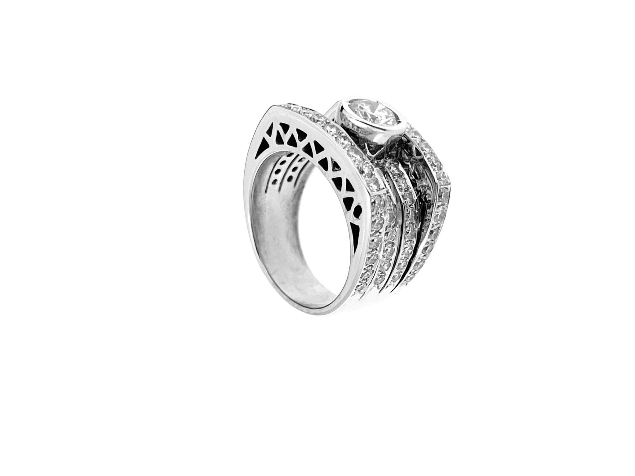 The Art Deco style Italian White Gold Ring features a blend of geometric shapes, sleek lines, and luxurious materials, typical of the Art Deco movement that flourished in the 1920s and 1930s. 

The ring is made of high-quality 18kt white gold, a