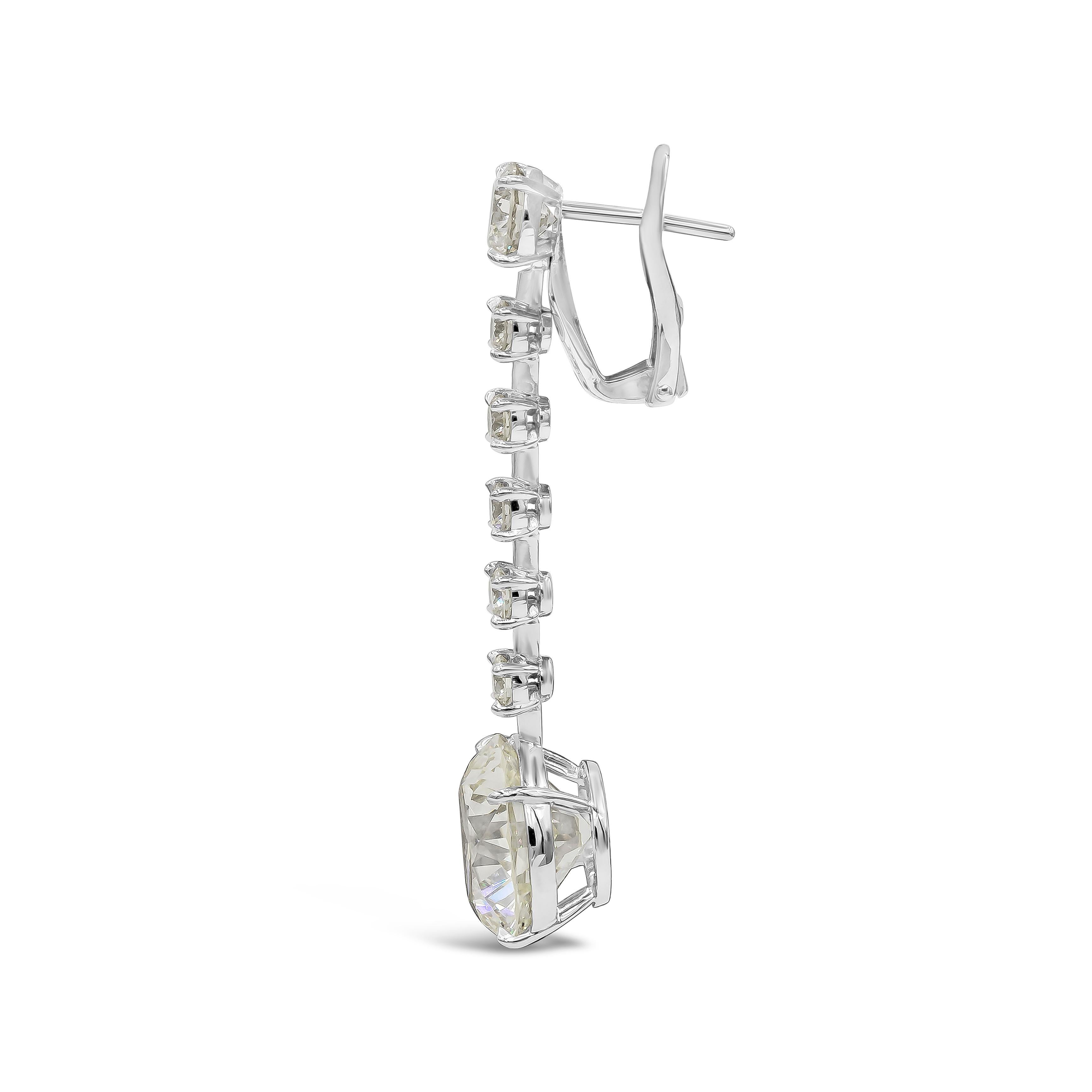 Elegant and well crafted dangle earrings showcasing 17.68 carats total round brilliant diamonds, N-O color, VS1 in clarity, suspended on a row of 6 round diamonds on each pair, weighing 3.40 carats total. Omega clip with collapsible post. Made with
