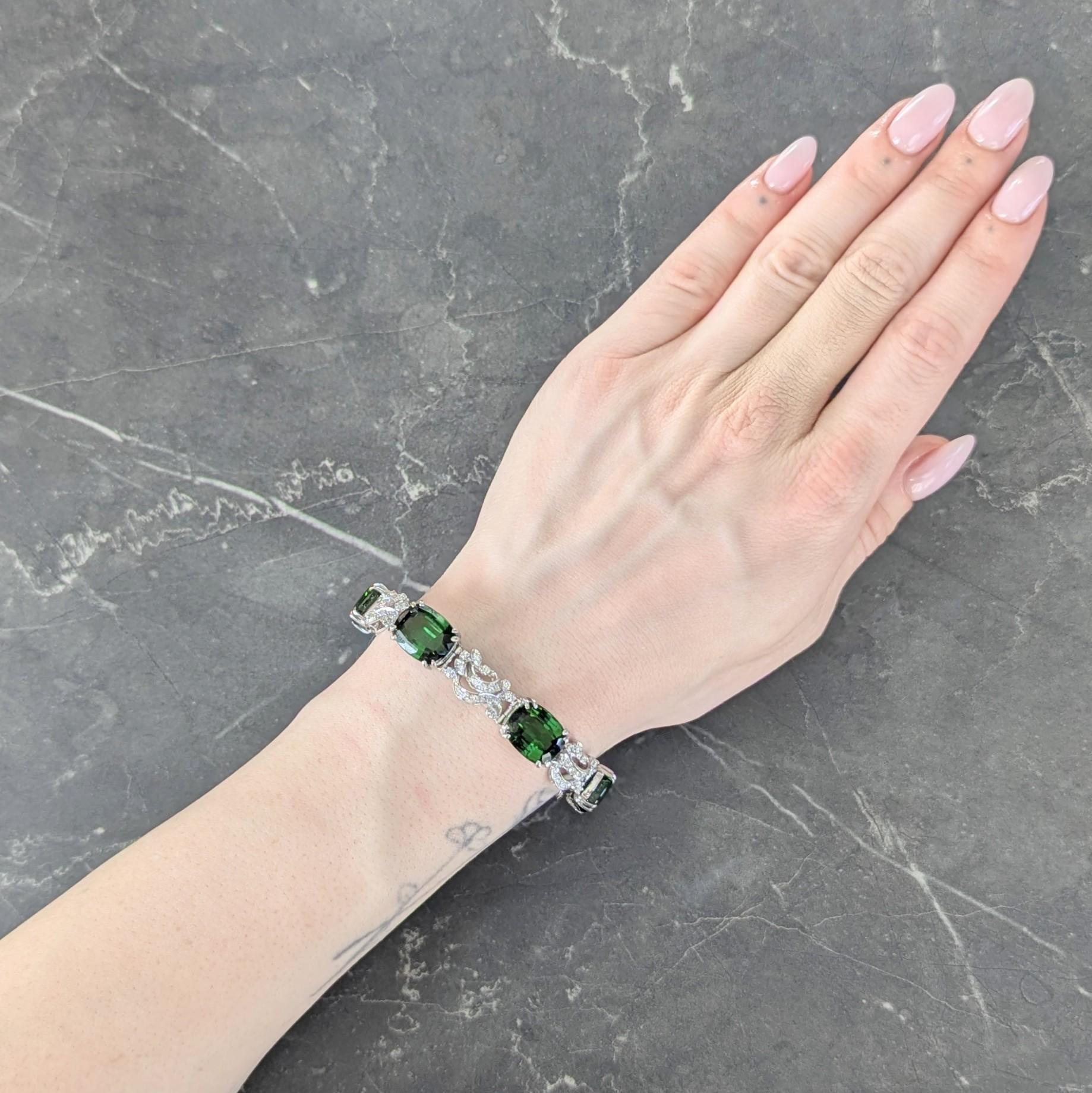 Comprised of hinged basket and scrolling ribbon motif links alternating in pattern
Basket links center elongated cushion cut tourmalines set with split prongs
Weighing approximately 40.80 carats total - transparent medium green
Ribbon links are bead