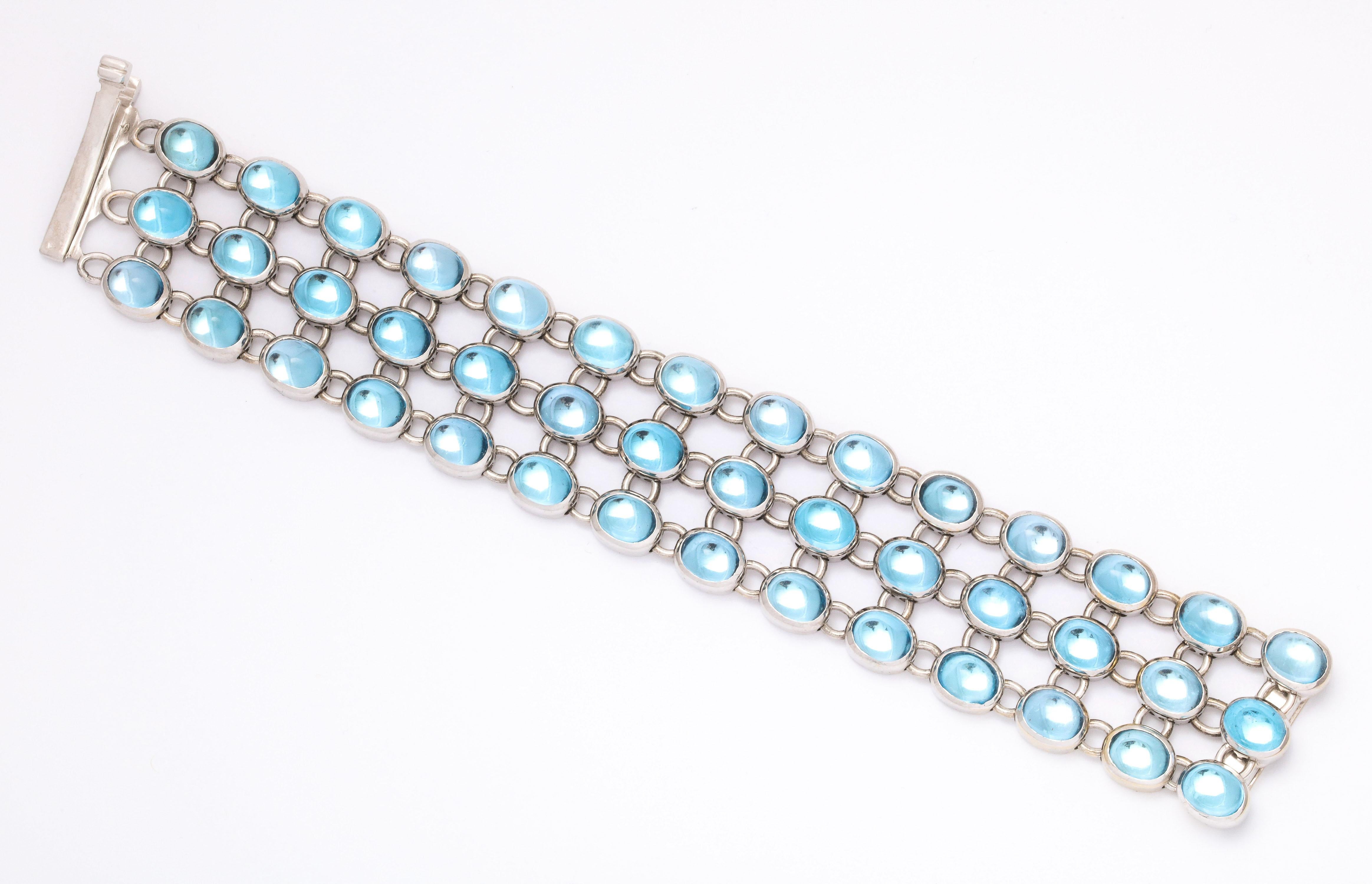 One Ladies Triple Row Cabochon Blue Topaz Highly Flexible Bracelet With Numerous Cabochon Blue Topazes Weighing Approximately 100 Carats.Mounted In A Heavy 18kt White Gold Mounting For Extra Security Of Stones And Allowing For Extra Flexiblity.