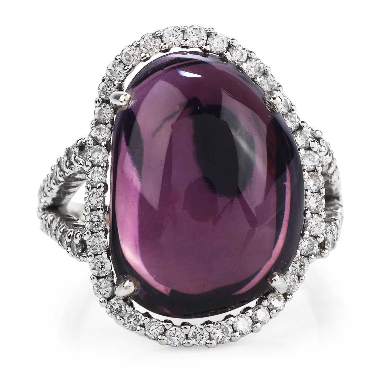 This H. Stern Diamond & Amethyst Cocktail Ring Crafted in solid 18K White & Yellow Gold. The center is adorned by an oval shape, cabochon cut, prong-set, Amethyst weighing 12.13 carats.

The halo design has (70) round cut, pave set, genuine diamonds