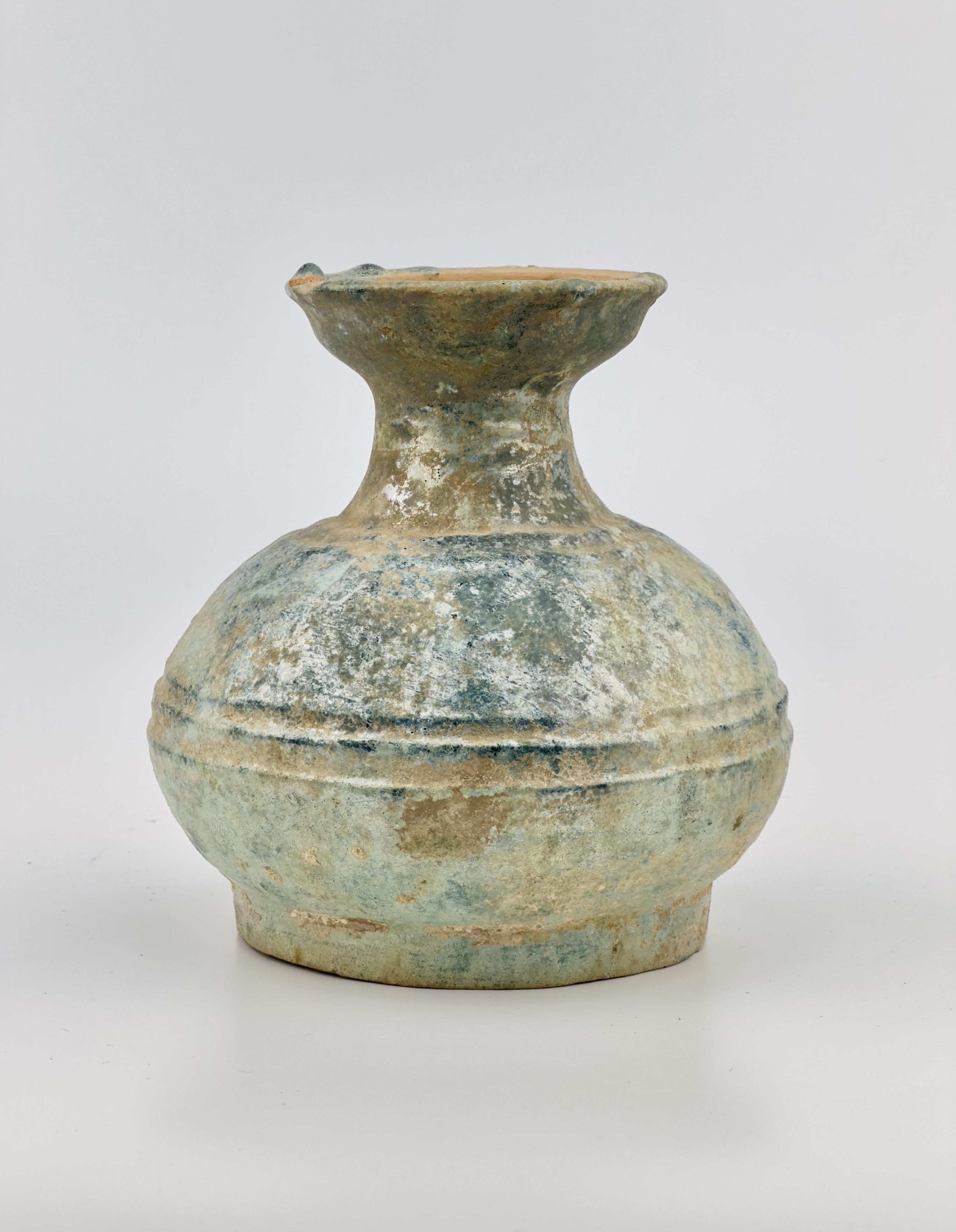 A 'Hu' is a type of large jar or pot that was commonly used in China for storage purposes, including holding liquids or dry goods like grains. This particular shape of pottery usually features a wide body and a narrow opening, and sometimes comes