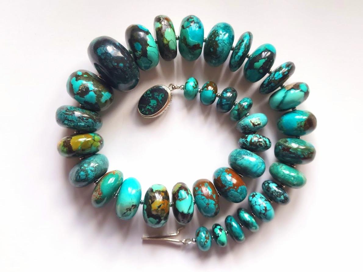 The length of the necklace is 22 inches (56 cm). The size of the rondelle beads varies from 16 mm to 40 mm.
Turquoise ranges in color from a light shade of green to light blue to a beautiful dark blue. Turquoise beads have a dark brown or black