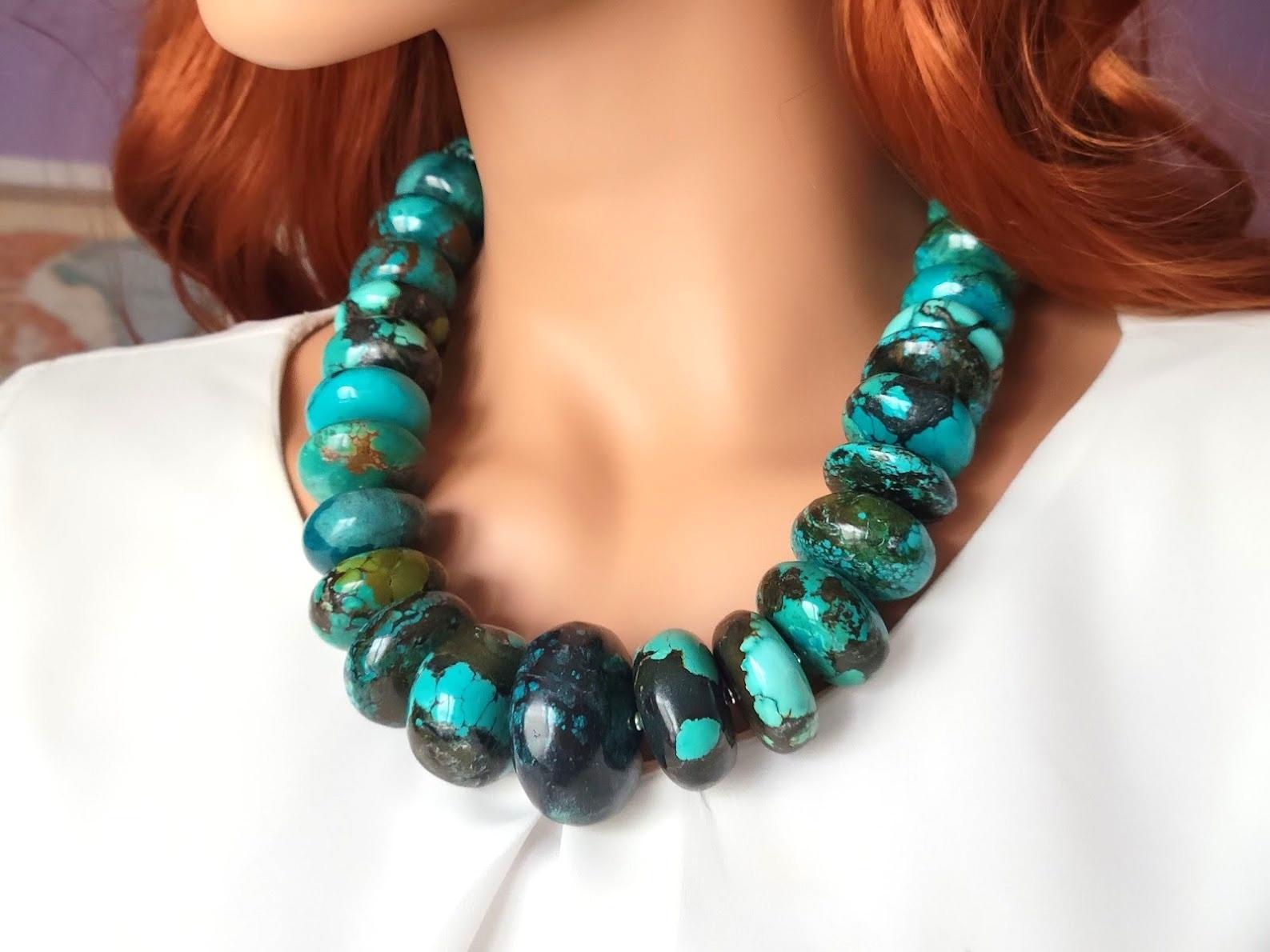 The length of the necklace is 22 inches (56 cm). The size of the rondelle beads varies from 16 mm to 40 mm.
Turquoise ranges in color from a light shade of green to light blue to a beautiful dark blue. Turquoise beads have a dark brown or black