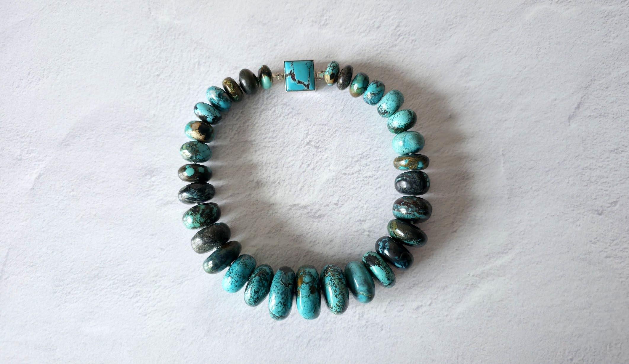 The length of the necklace is 18.5 inches (47 cm).
The size of the rondelle beads varies from 16 mm to 33.5 mm.
Turquoise ranges in color from a light shade of green to light blue to a beautiful dark blue. Turquoise beads have a dark brown or black