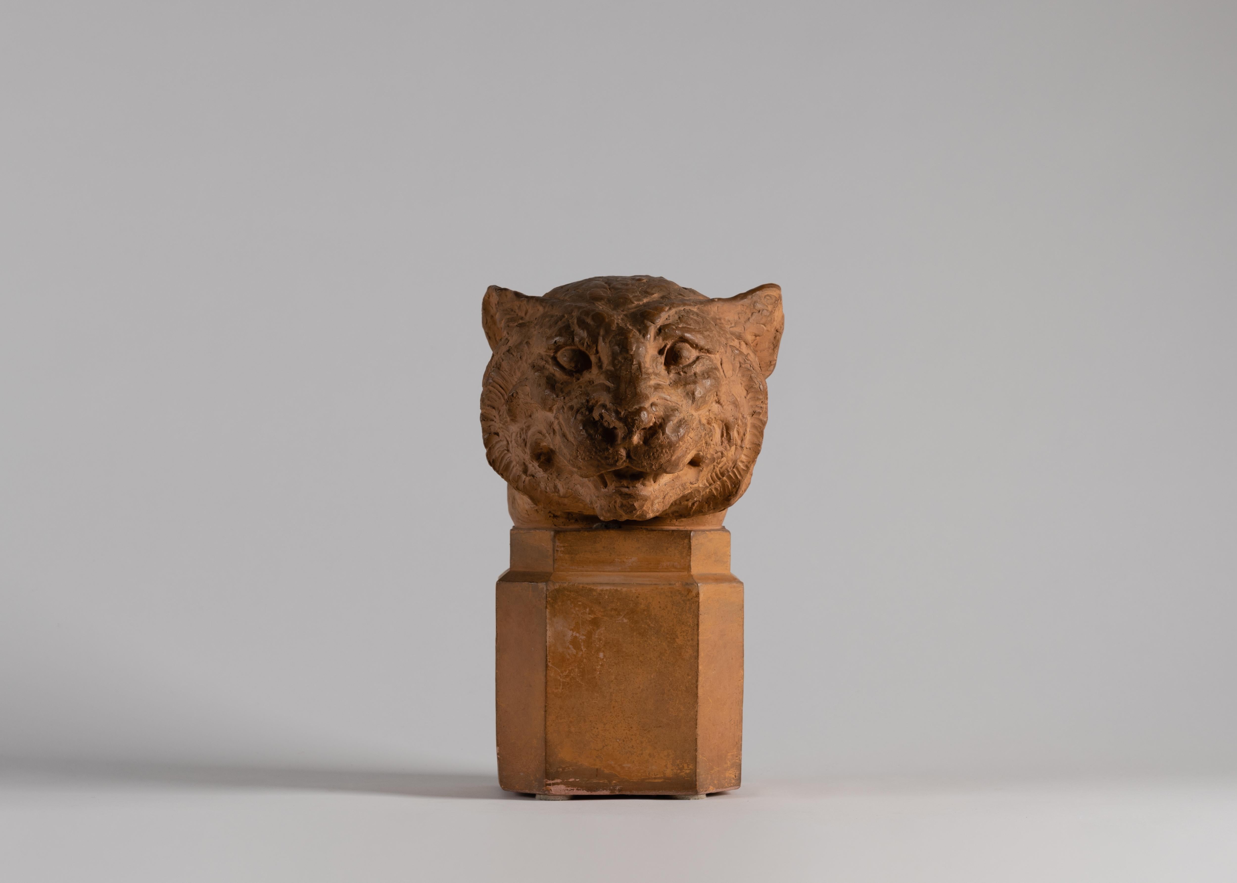 This charming bust playfully upends a classical form with an unusual, yet surprisingly fitting subject. Made of terracotta, the puma's head crowns an octagonal column, addressing its audience with the quiet dignity of a Roman senator. 

Signed: