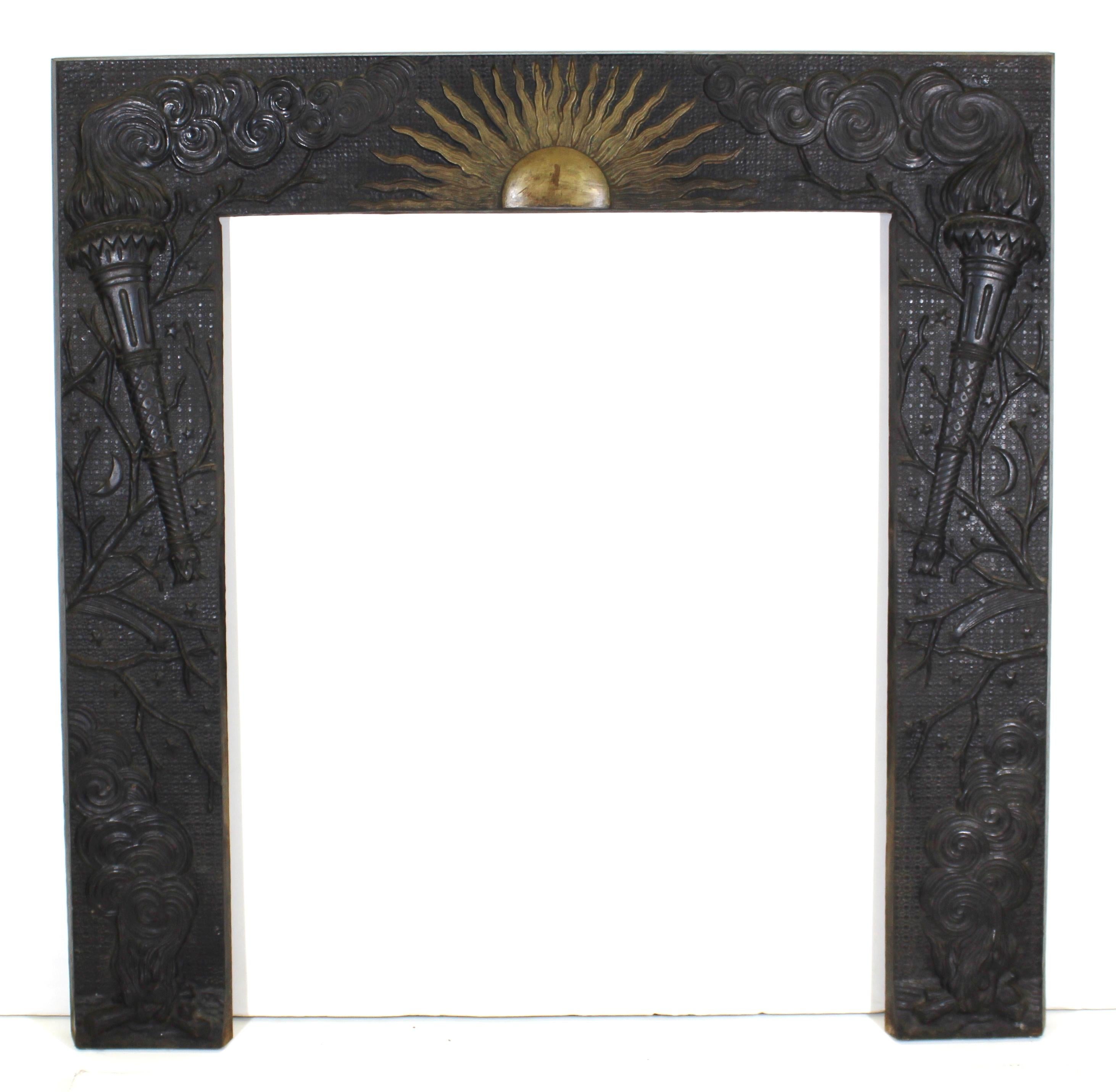 American Aesthetic Movement fireplace surround from the Hotel Chelsea in New York City, designed by the architectural practice of Hubert, Pirrson & Company. The piece presents a night and day theme with an applied bronze sun centered on a cast iron