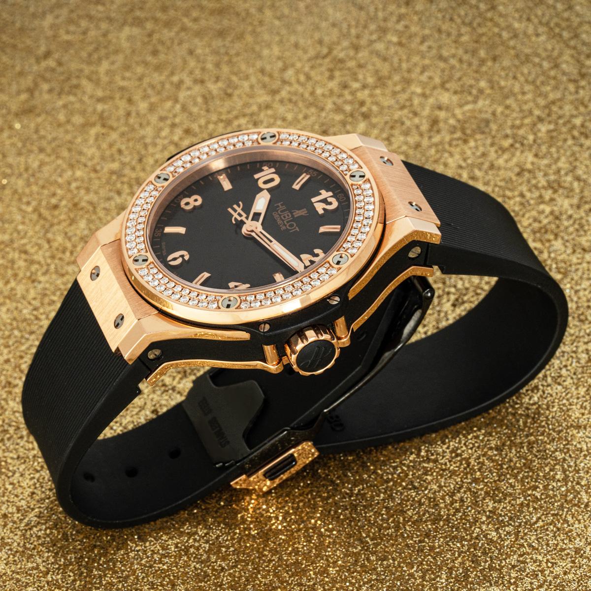 A ladies 38mm Big Bang in rose gold from Hublot. Features a black dial and a rose gold bezel, set with approximately 126 round brilliant cut diamonds.

Fitted with sapphire crystal and a quartz movement. The watch is equipped with an original black