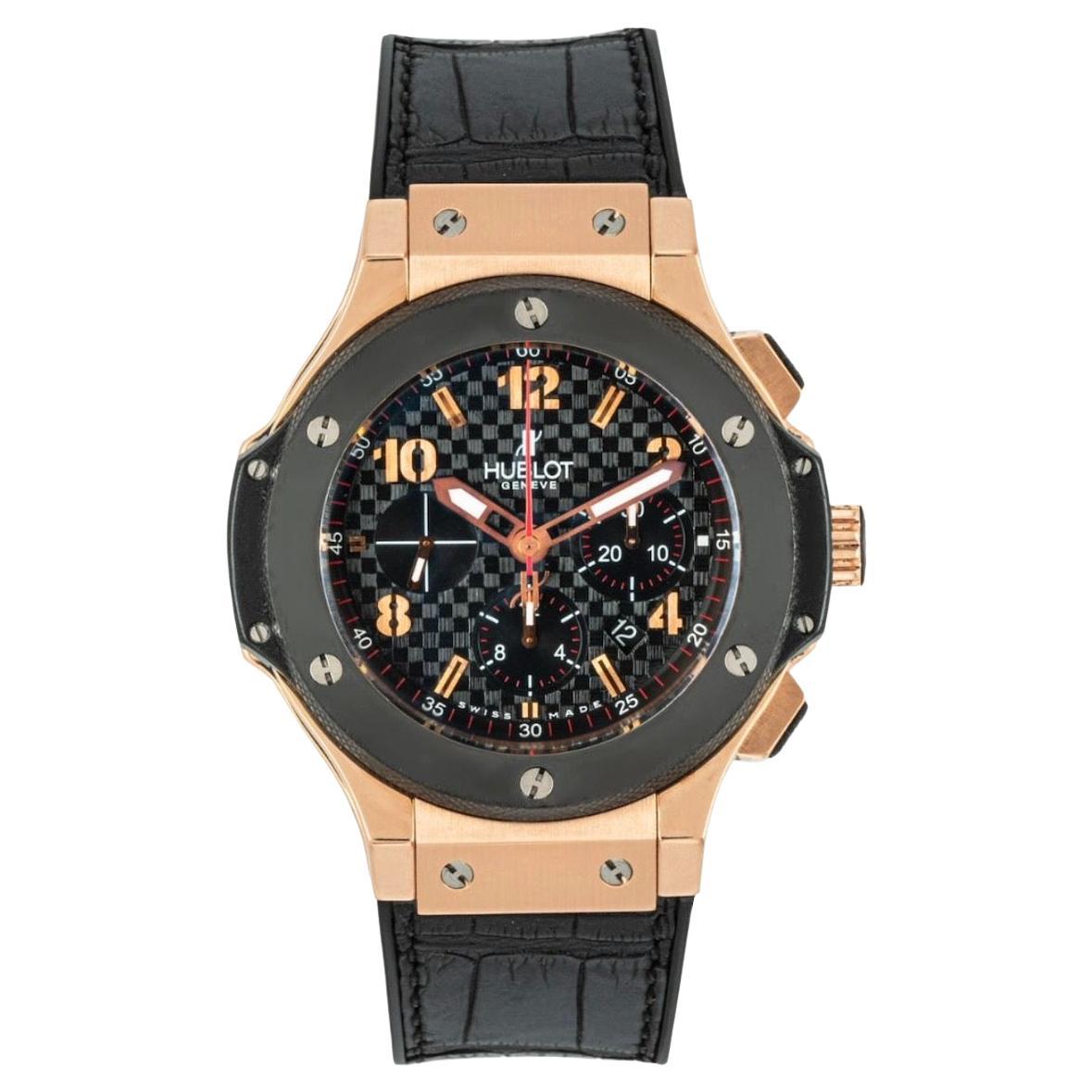 An 18k rose gold Big Bang wristwatch by Hublot. Featuring a black carbon effect dial with applied arabic numbers, chronograph counters, and a fixed black ceramic bezel set with the six iconic Hublot titanium H screws.

Equipped with a Hublot black