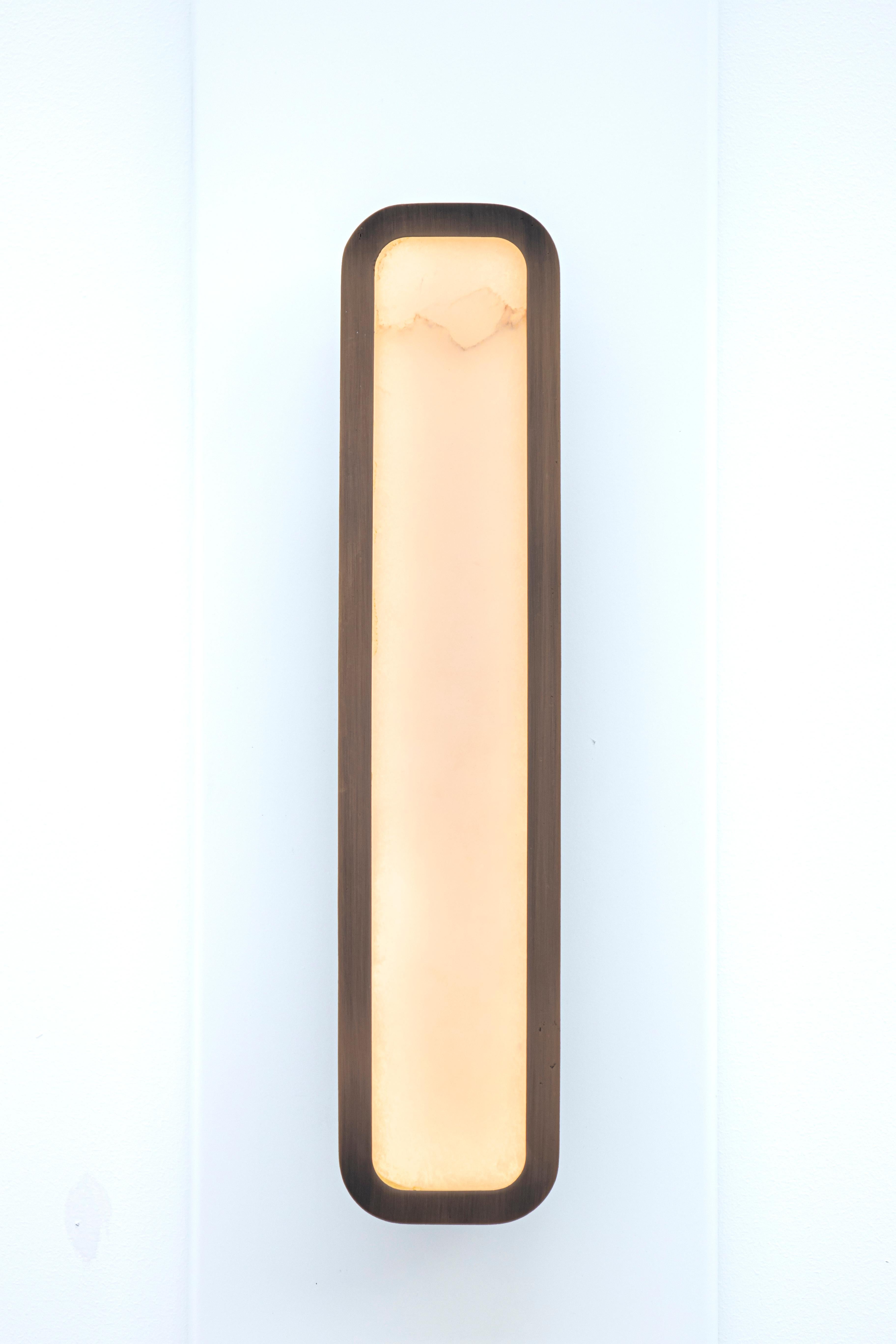 Hublot wall lamp by Entrelacs
Designer: Yves Macheret
Materials: Patinated bronze, alabaster
Dimensions: 10.9 x 2.95 x 50 cm

Handmade in France.
Body lamp patinates bronze, protective varnish - Alabaster diffuser
220-240V / 50-60hz / 24V -