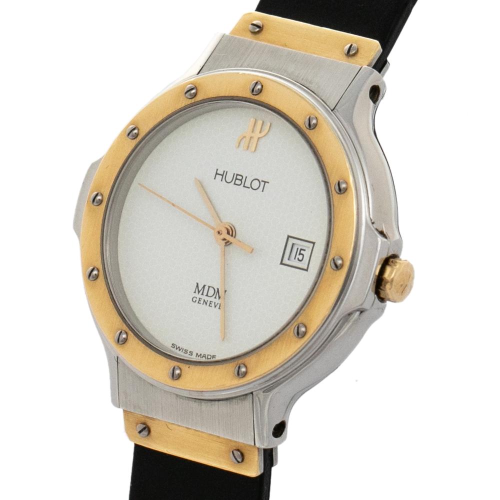 A defined timepiece like the Hublot MDM 1391.2 adds a lot to one's everyday style. It features a stainless steel and 18k yellow gold case and a rubber bracelet. This watch comes with exposed screw details and a round, white dial set with three hands