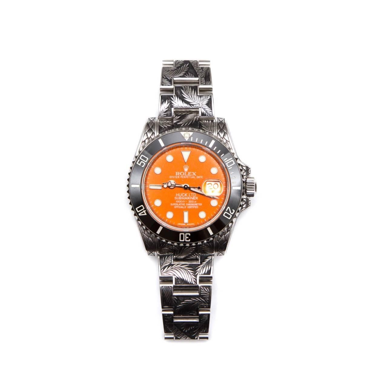 Huckleberry Ltd engraved Rolex Submariner with palm tree motif, hummingbird animal totem with white diamond eye, black bezel, custom Huckleberry orange dial and orange date-wheel, suede lined wooden box and lifetime warrantee.