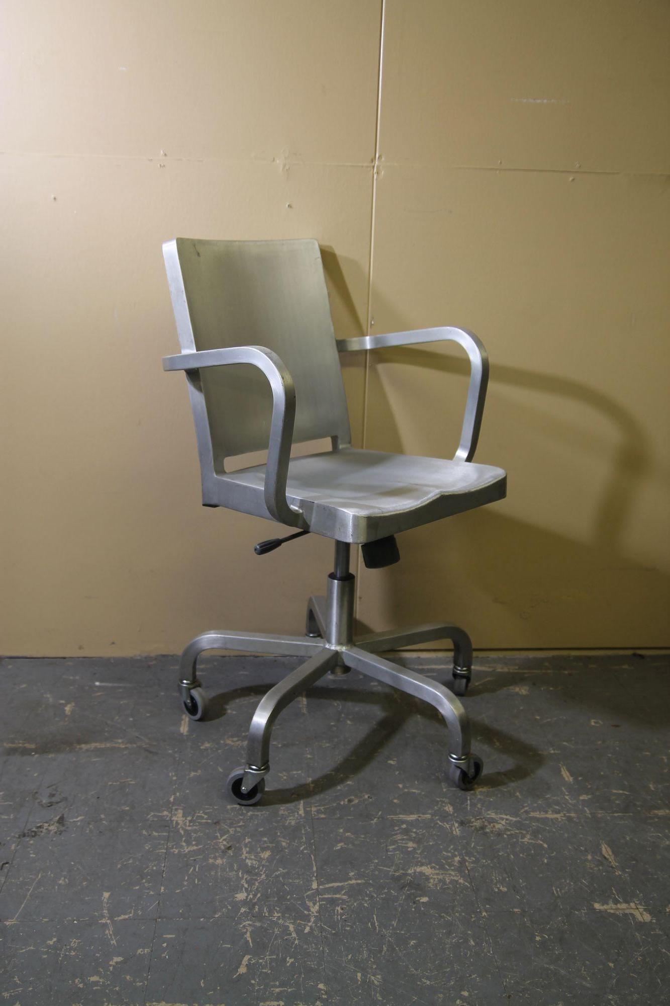 Pleased to offer this great brushed aluminum chair from Emeco. This Starck designed chair sits on 4 wheels. Chair is in nice vintage shape. There are some light scratches as well as a nick on the seat that is noted in my photos.