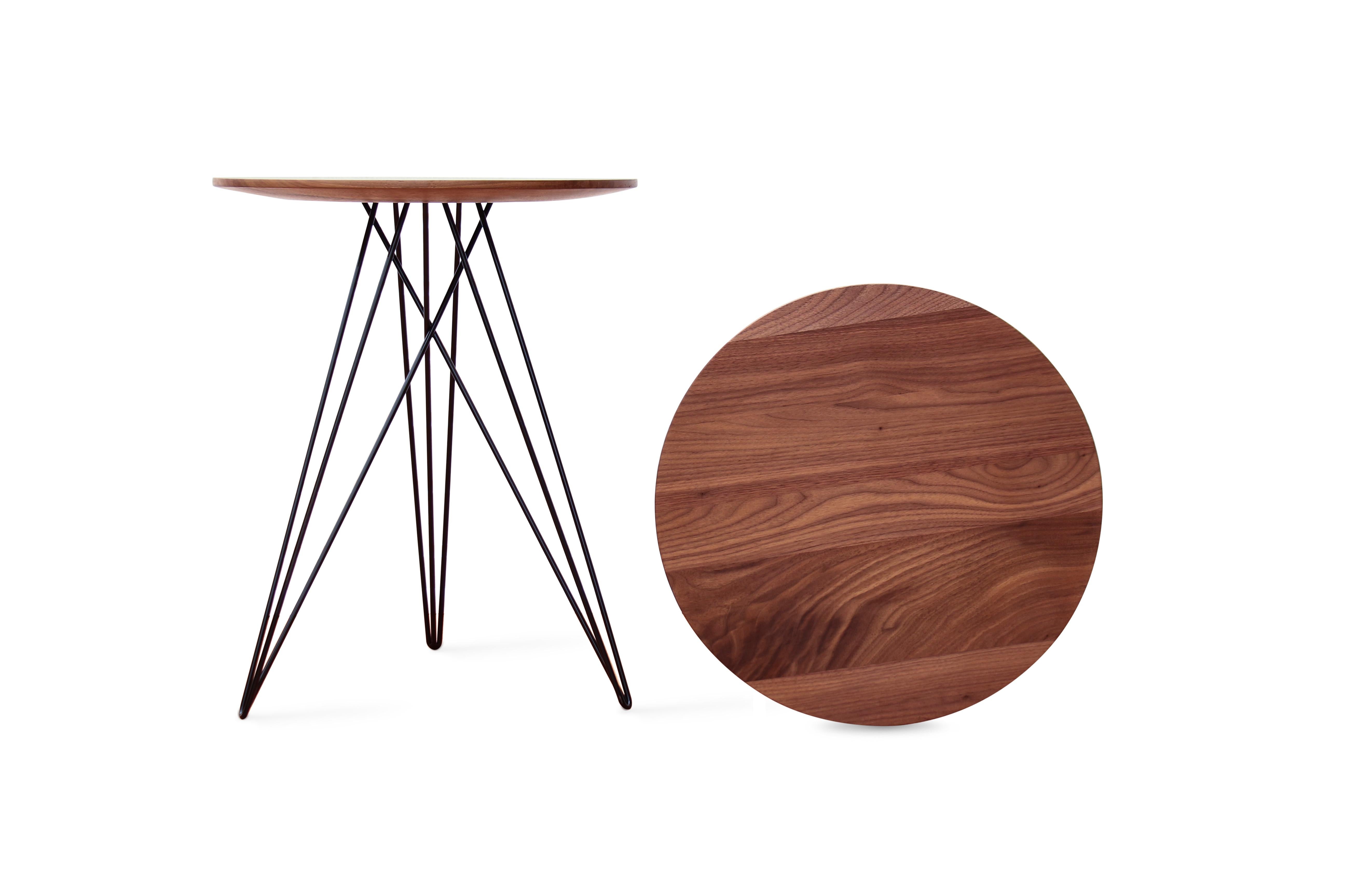 This eye-catching piece combines an industrial structure with sophisticated modern accents. The intersecting metal legs almost seem to play tricks on the eyes and change shape as you circle around the table. It is finished with a slim and elegantly