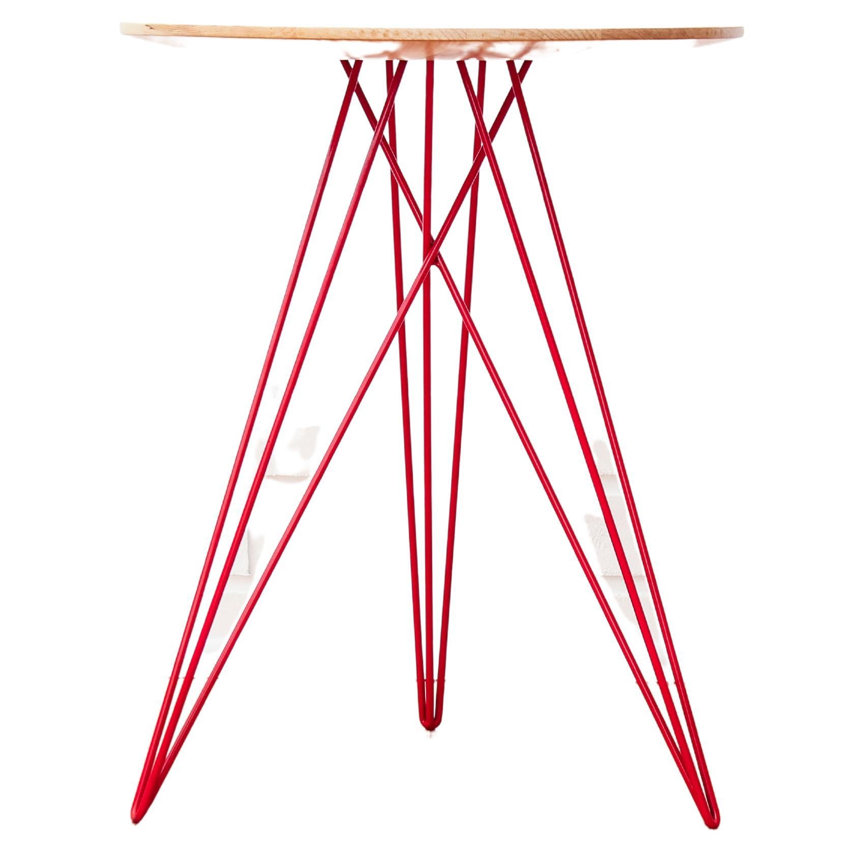 This eye-catching piece combines an industrial structure with sophisticated modern accents. The intersecting metal legs almost seem to play tricks on the eyes and change shape as you circle around the table. It is finished with a slim and elegantly