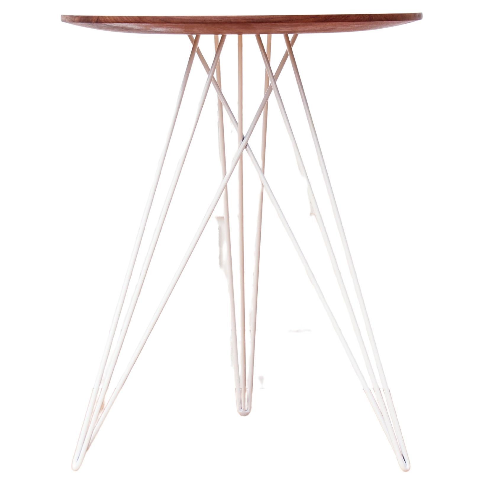 This eye-catching piece combines an industrial structure with sophisticated modern accents. The intersecting metal legs almost seem to play tricks on the eyes and change shape as you circle around the table. It is finished with a slim and elegantly