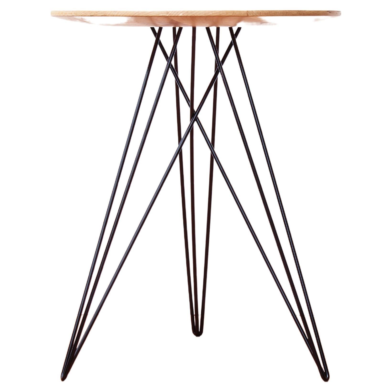 This eye-catching piece combines an industrial structure with sophisticated modern accents. The intersecting metal legs almost seem to play tricks on the eyes and change shape as you circle around the table. It is finished with a slim and elegantly