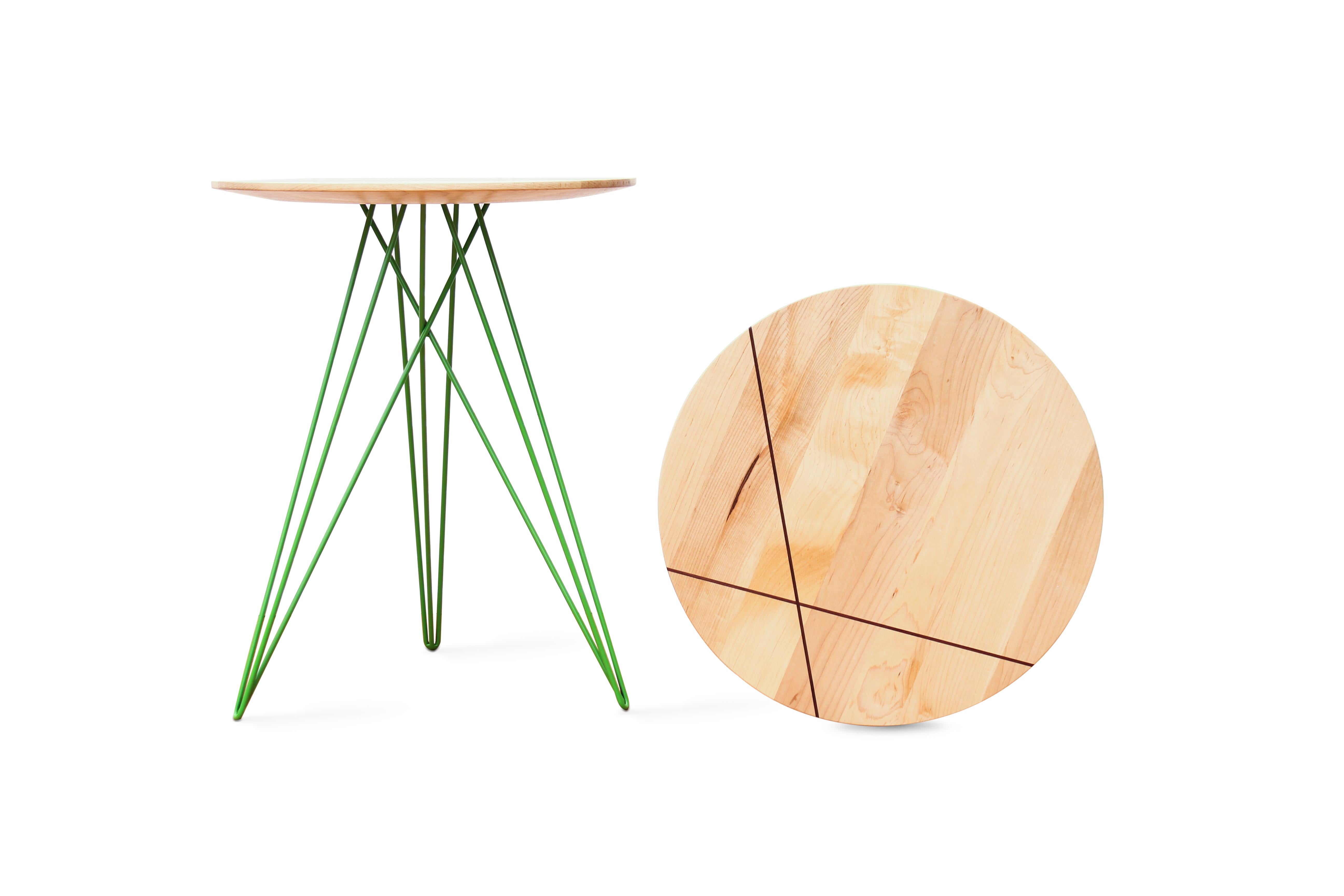 This eye-catching piece combines an industrial structure with sophisticated modern accents. The intersecting metal legs almost seem to play tricks on the eyes and change shape as you circle around the table. It is finished with a slim and elegantly