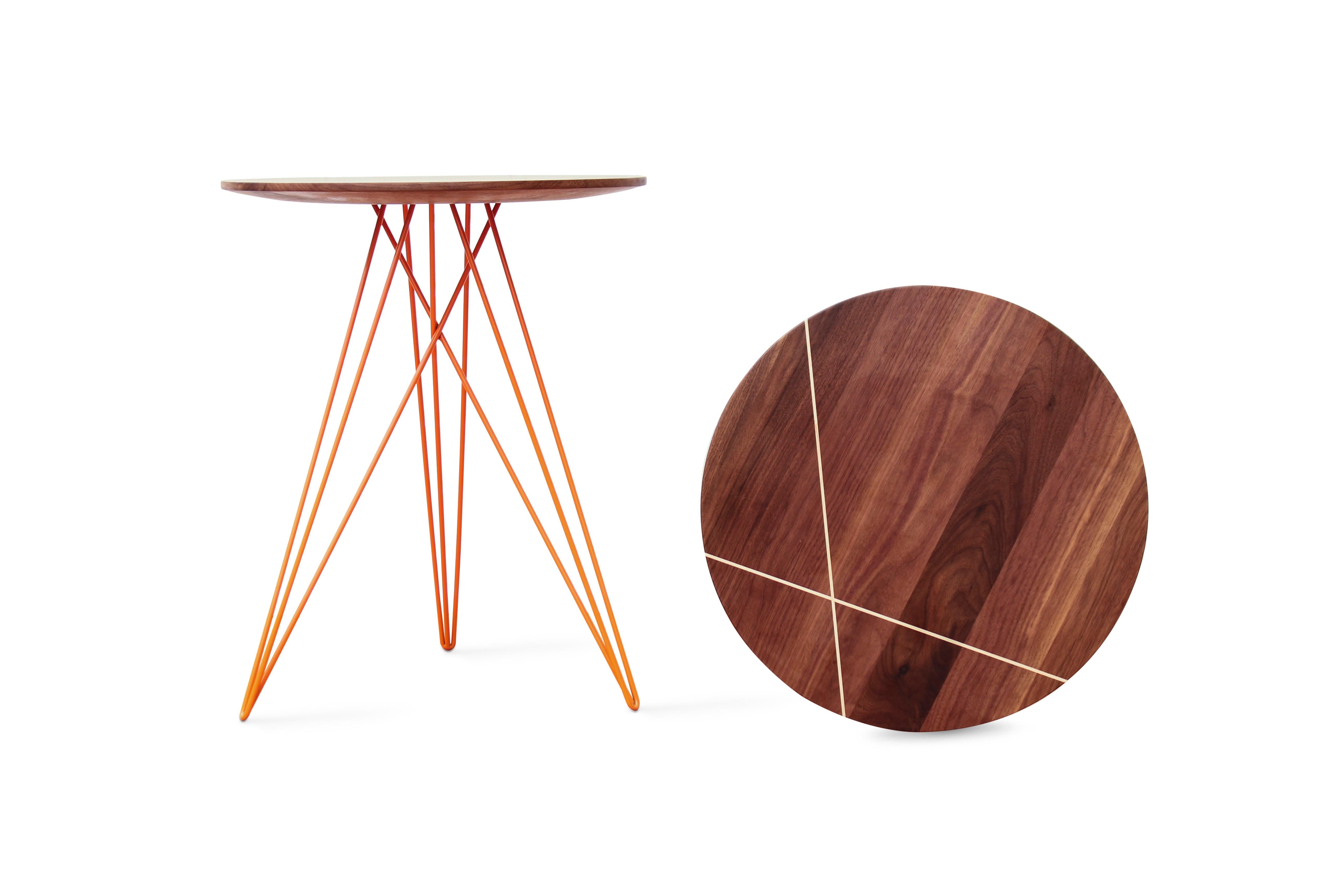 This eye-catching piece combines an industrial structure with sophisticated modern accents. The intersecting metal legs almost seem to play tricks on the eyes and change shape as you circle around the table. It is finished with a slim and elegantly