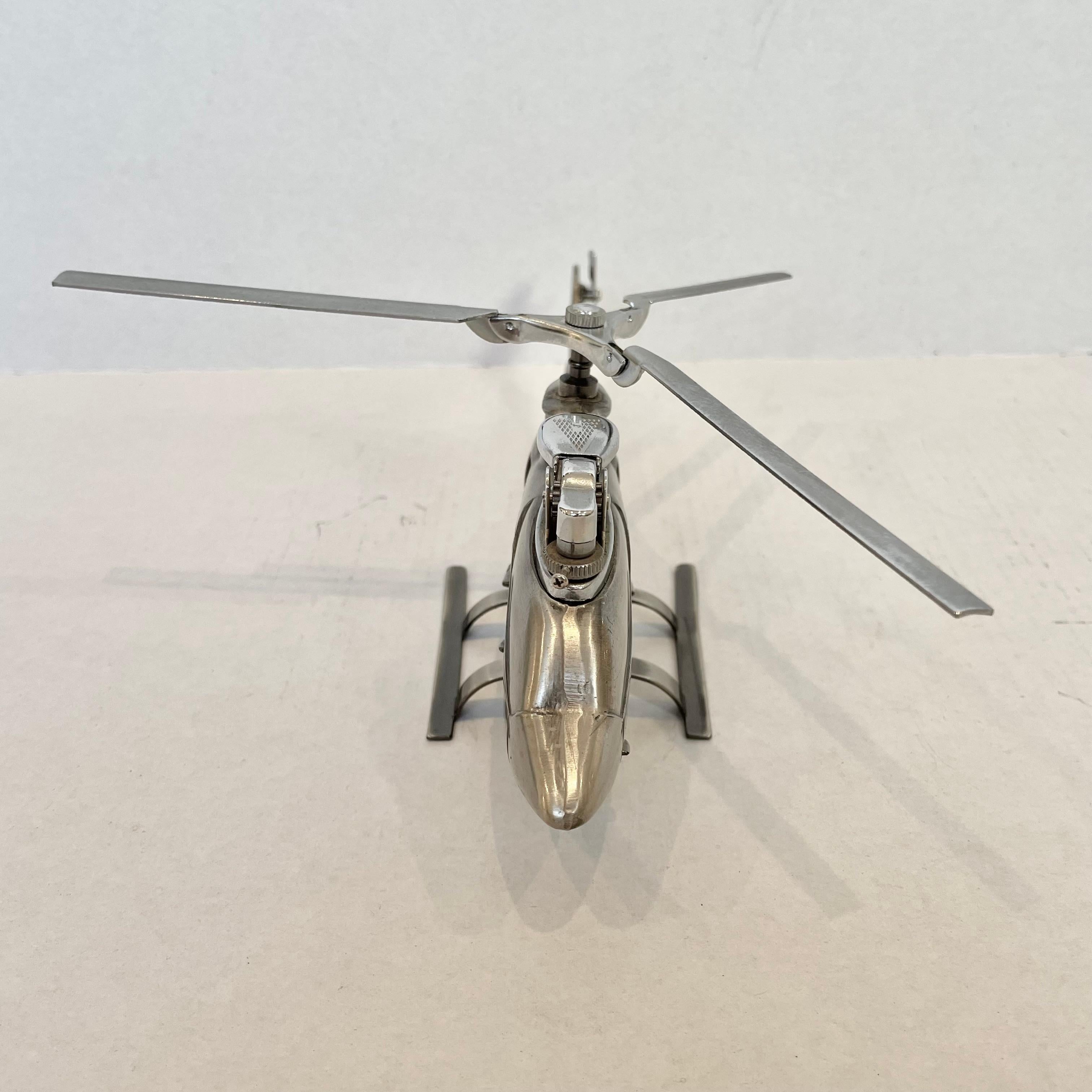 Cool vintage table lighter in the shape of a Huey Cobra Helicopter. Made in Japan, 1980s. This piece has great balance and details like propellers that spin and fold up. Cool tobacco accessory and conversation piece. Working lighter. Good vintage