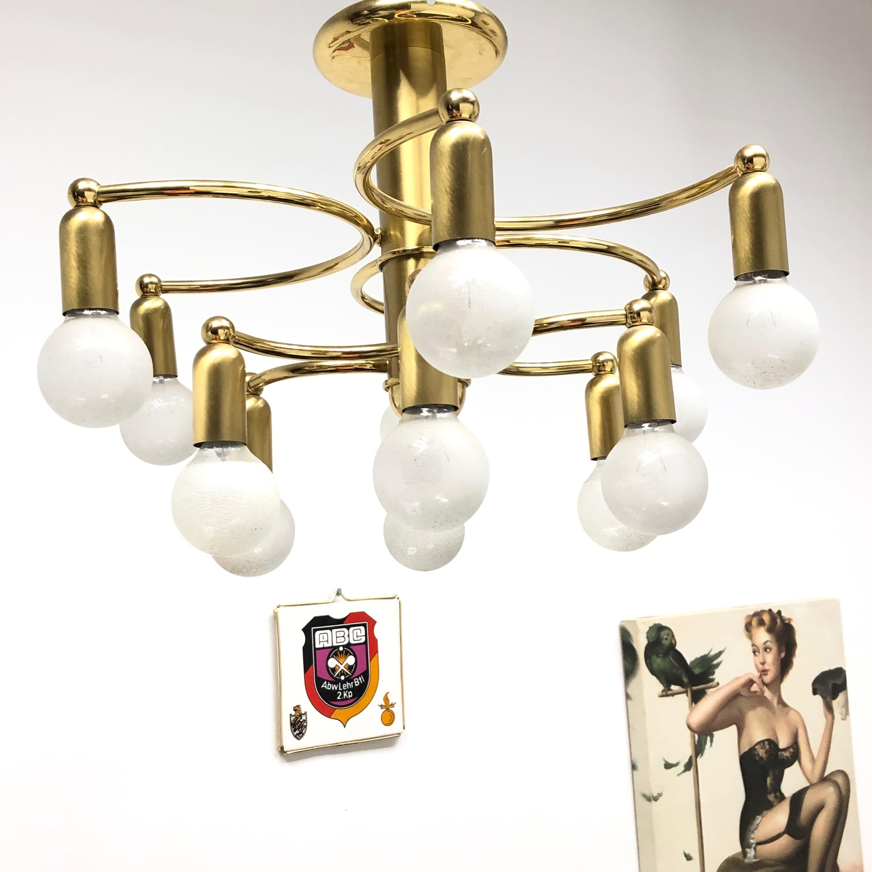 A gorgeous brass flush mount by Hufnagel Leuchten. It can be used also as a sconce. The light fixture requires twelve European E14 candelabra bulbs, each up to 40 watts. It measures approximate 11