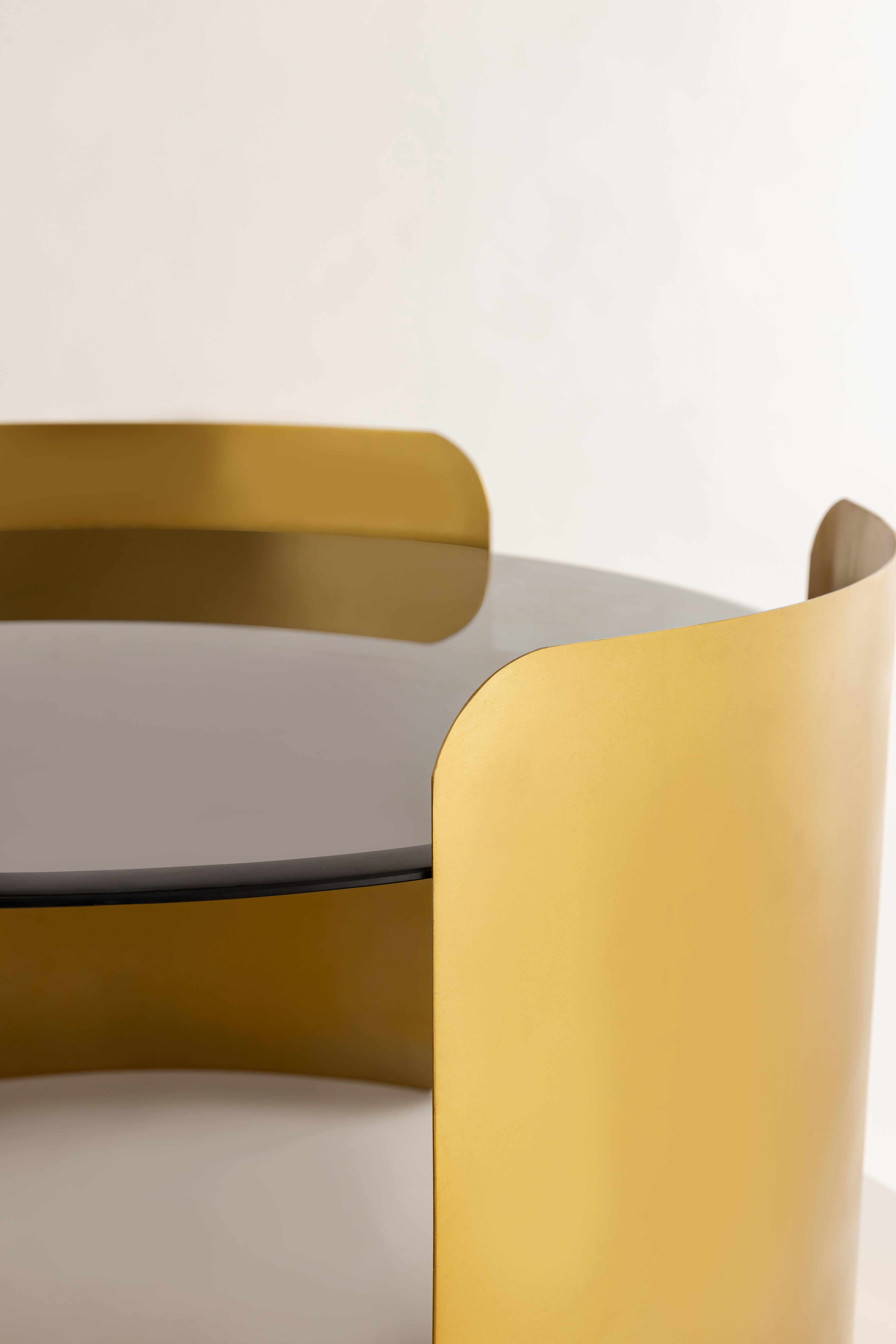 Your day just got cozier with the Hug Coffee Table. Finely crafted without a single harsh edge, this table is an embodiment of affection and elegance.

The circular top is gracefully enveloped by three metal sheets, curving around it like a loving