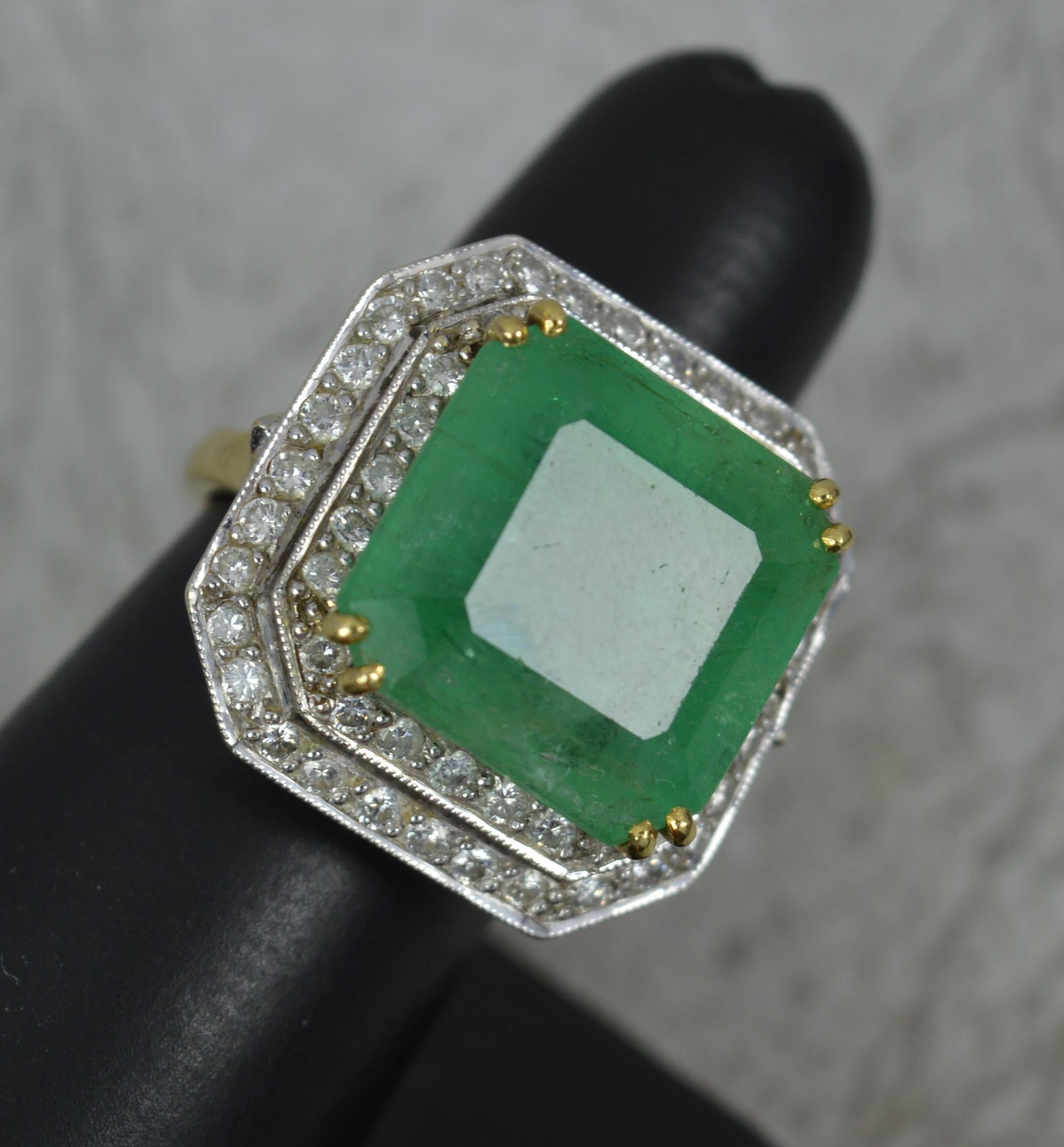 A stunning and large Emerald and Diamond cocktail ring.
Solid 18 carat yellow gold shank with platinum head setting.
Designed with a square shaped natural emerald to centre. 15mm x 14mm approx 15 carats. Surrounding are two rows of round brilliant