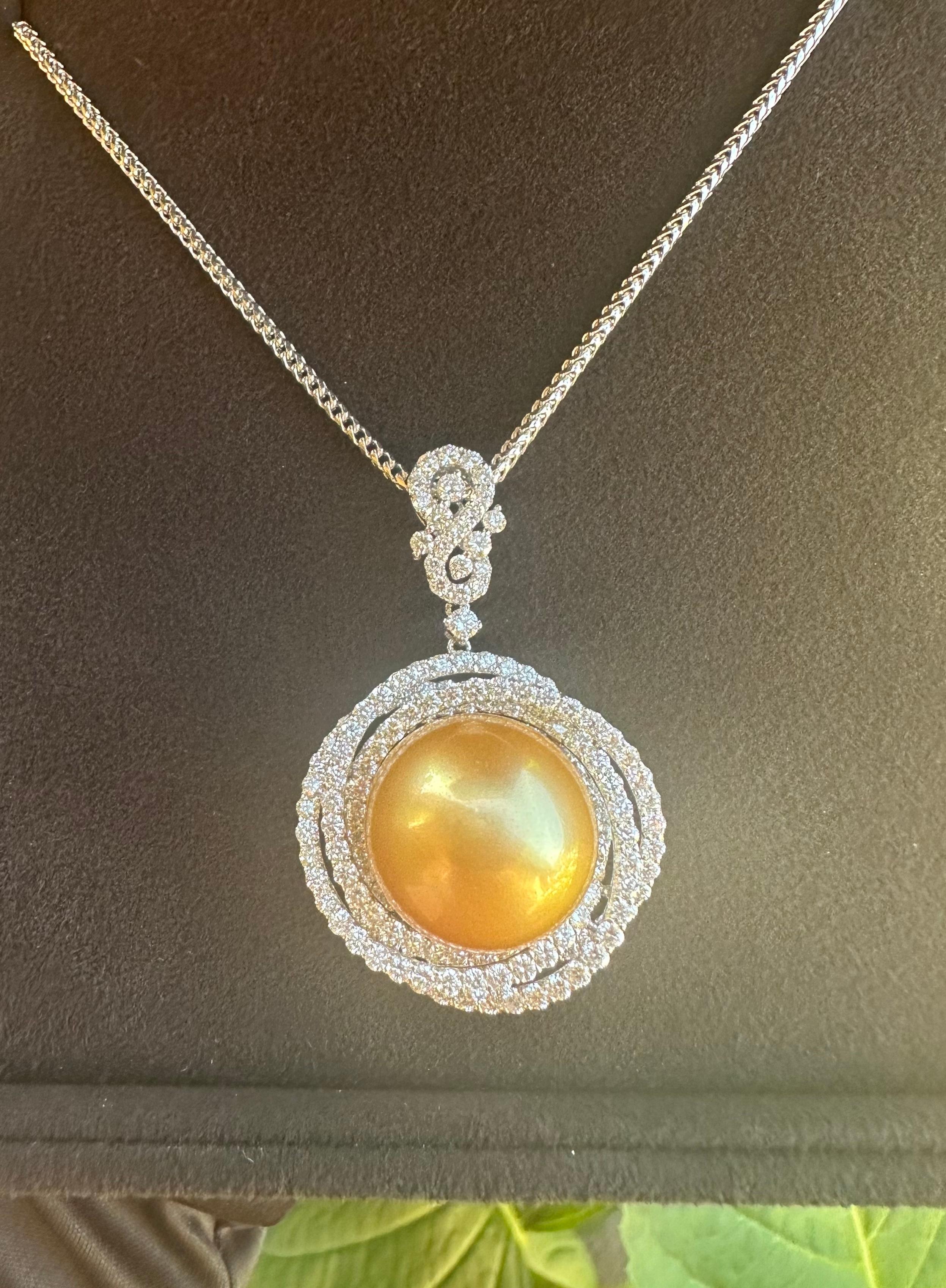 Magnificent, huge, single round AAAA grade finest quality 16.75 mm golden South Sea pearl, with high luster and shine, is surrounded by approximately 206 round brilliant diamonds in an 18 karat white gold pendant mounting. This pendant is