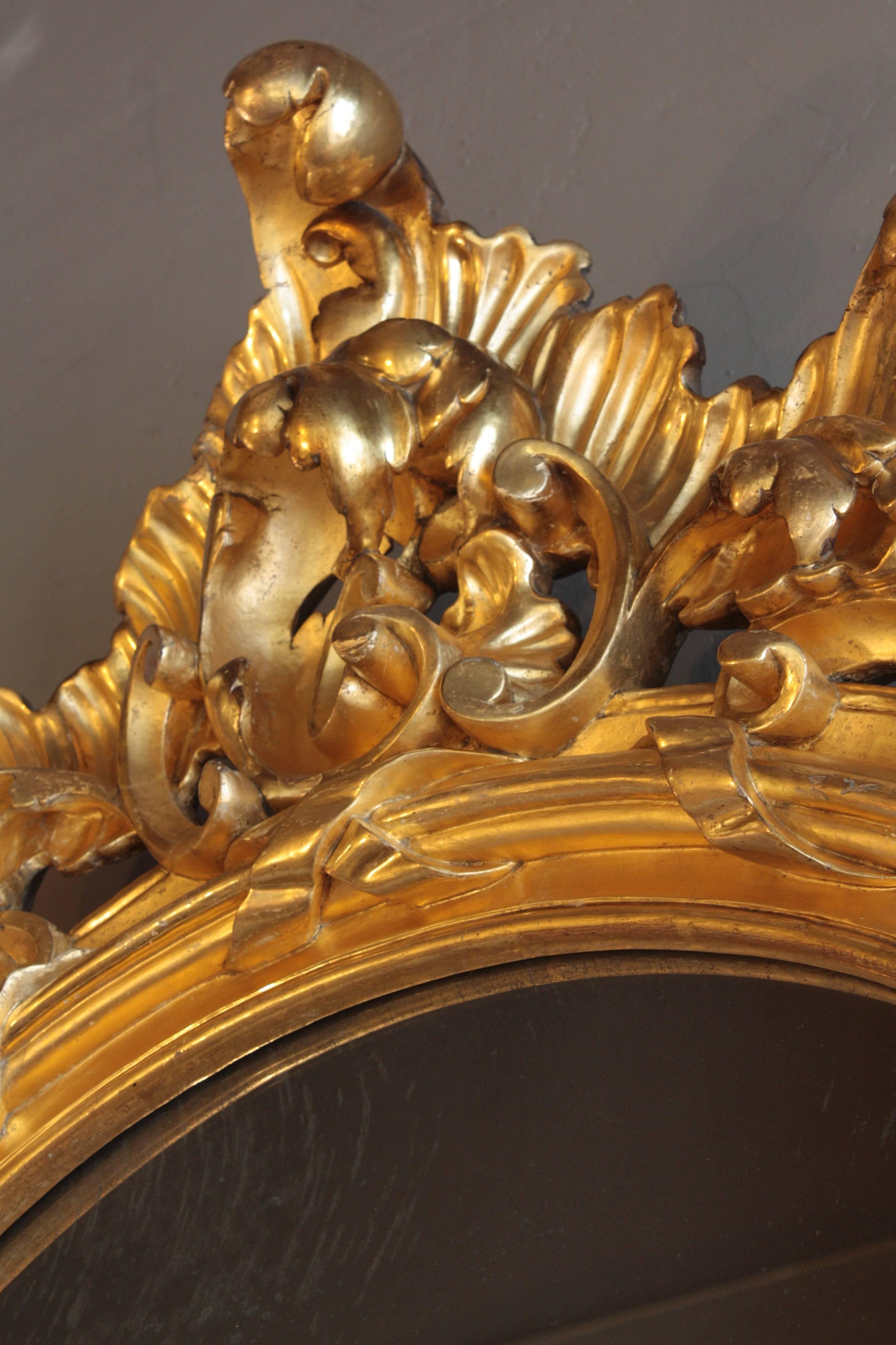 French Rococo Carved Giltwood Palatial Oval Mirror For Sale 2