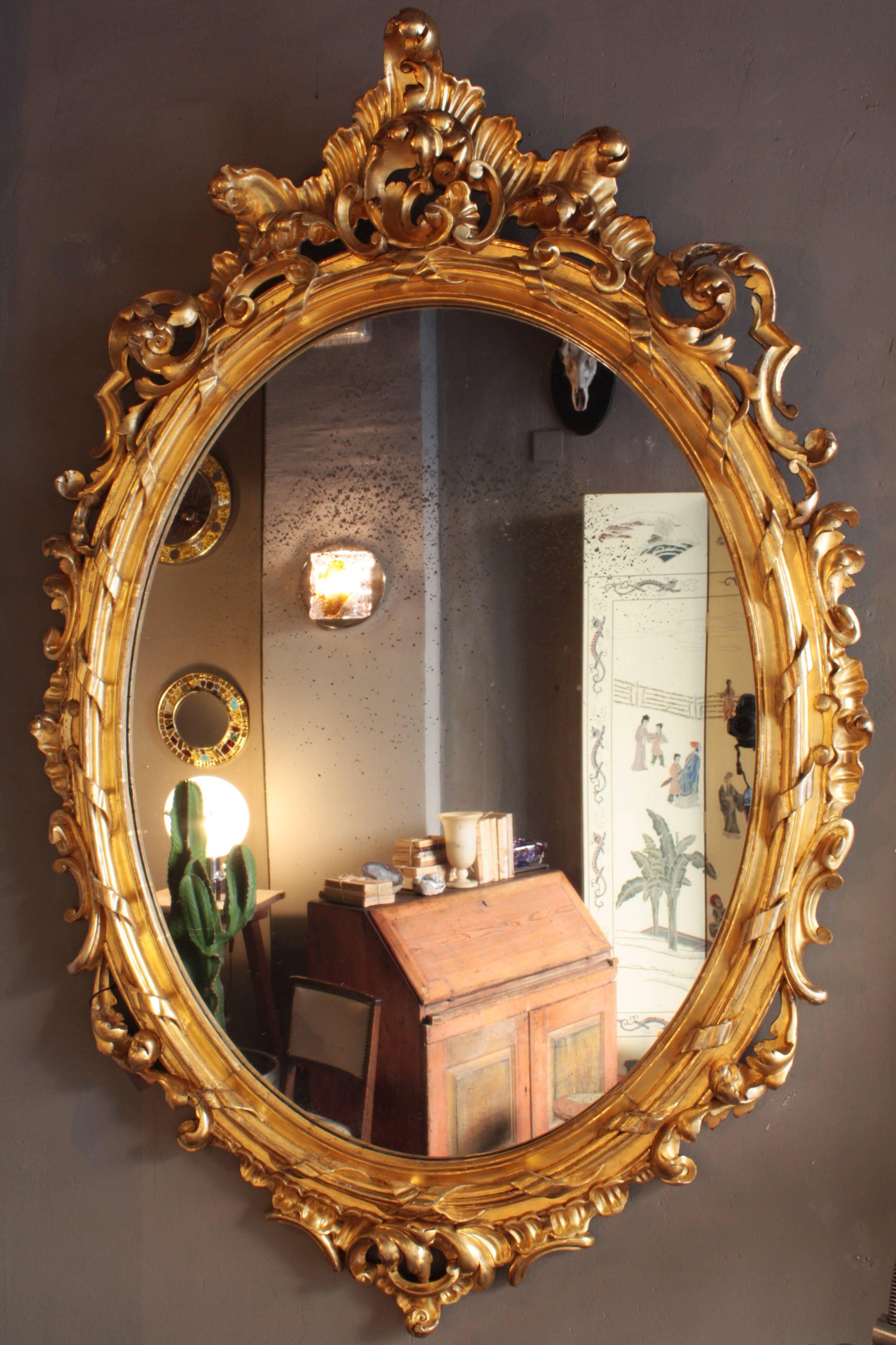 Outstanding finely carved palatial Rococo style mirror with gold leaf finish in a very big size. France, 1850.
A superb example of gilt Rococo style framework.
The frame has a beautiful carved decoration with acanthus leaves, scrolls and ribbons
