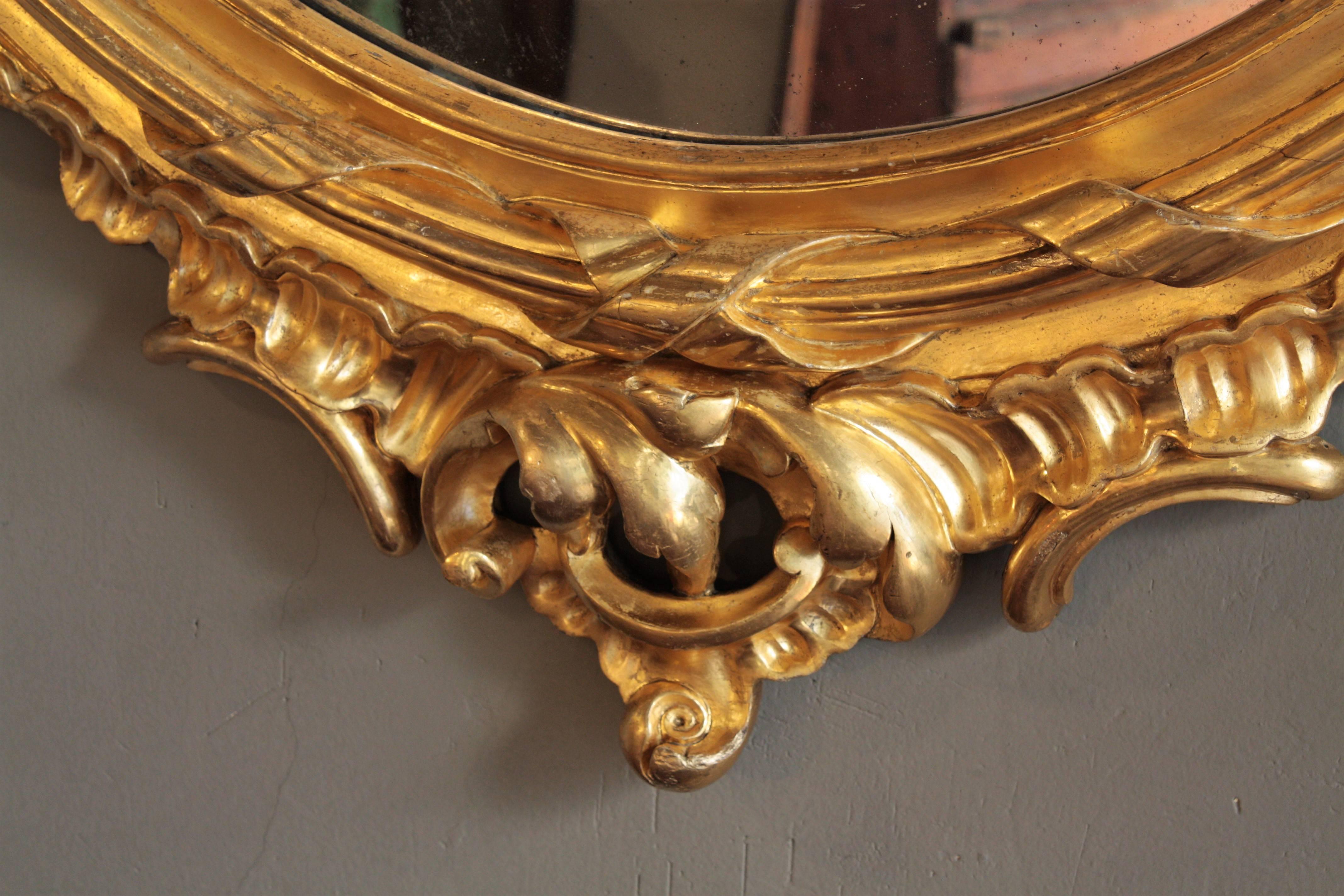 French Rococo Carved Giltwood Palatial Oval Mirror For Sale 1