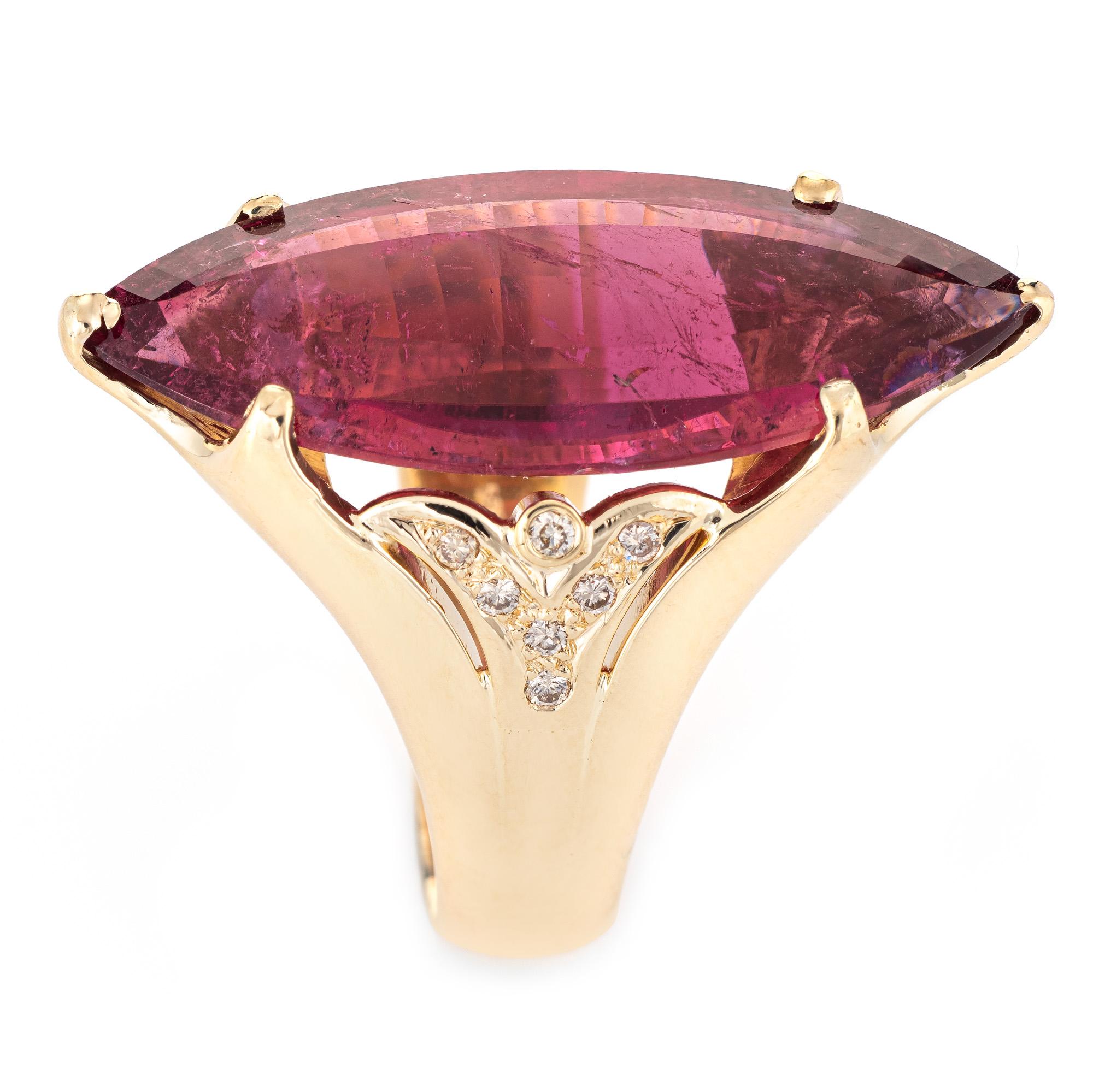 Striking vintage pink tourmaline & diamond cocktail ring (circa 1970s to 1980s) crafted in 14 karat yellow gold. 

Marquise shaped step cut pink tourmaline measures 33mm x 14mm (estimated at 20 carats), accented with an estimated 0.10 carats of