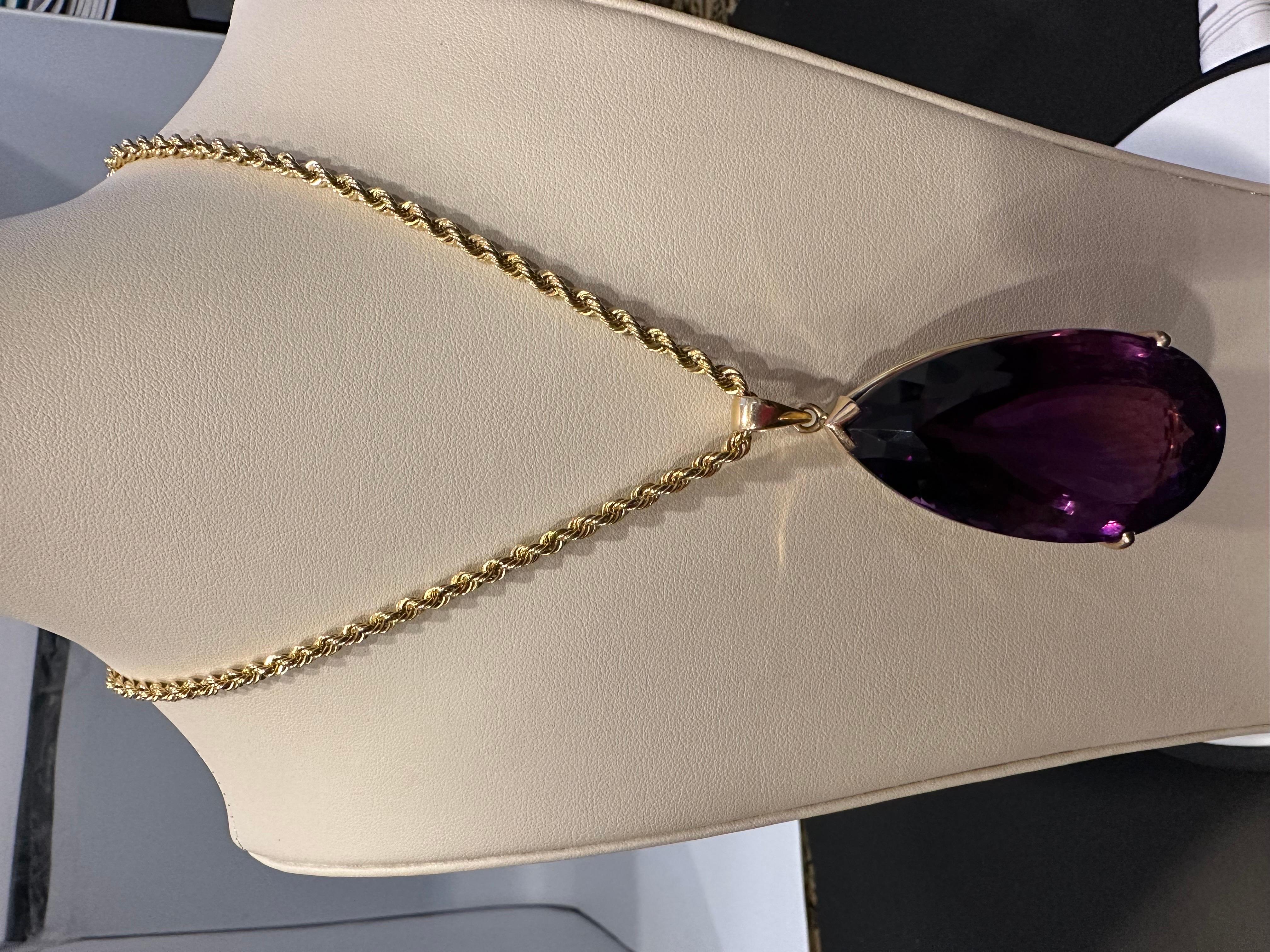This spectacular Pendant Necklace consists of a single large Perfect Pear shape Amethyst, weighing 233.36 Carat. The Amethyst has a Gold Frame around it, and it has a large bail. However, the chain is not included, and the pendant does not come with