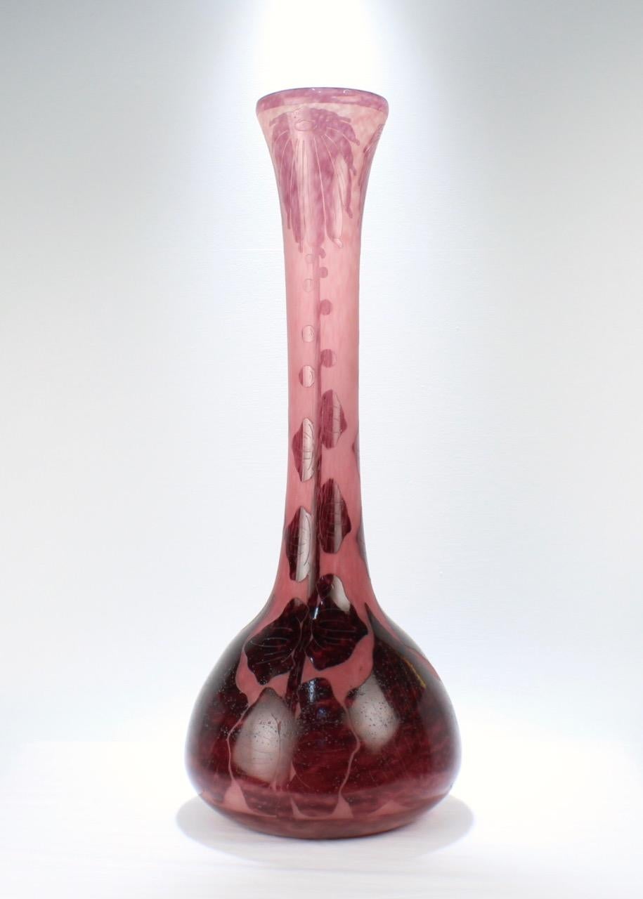 A monumentally large Charles Schneider French art glass floor vase. 

In the 'decor Dahlia' pattern.

The vase has a pink and purple palette and is decorated with large acid-cut flowers to the body.

Simply a tour-de-force of Art Nouveau