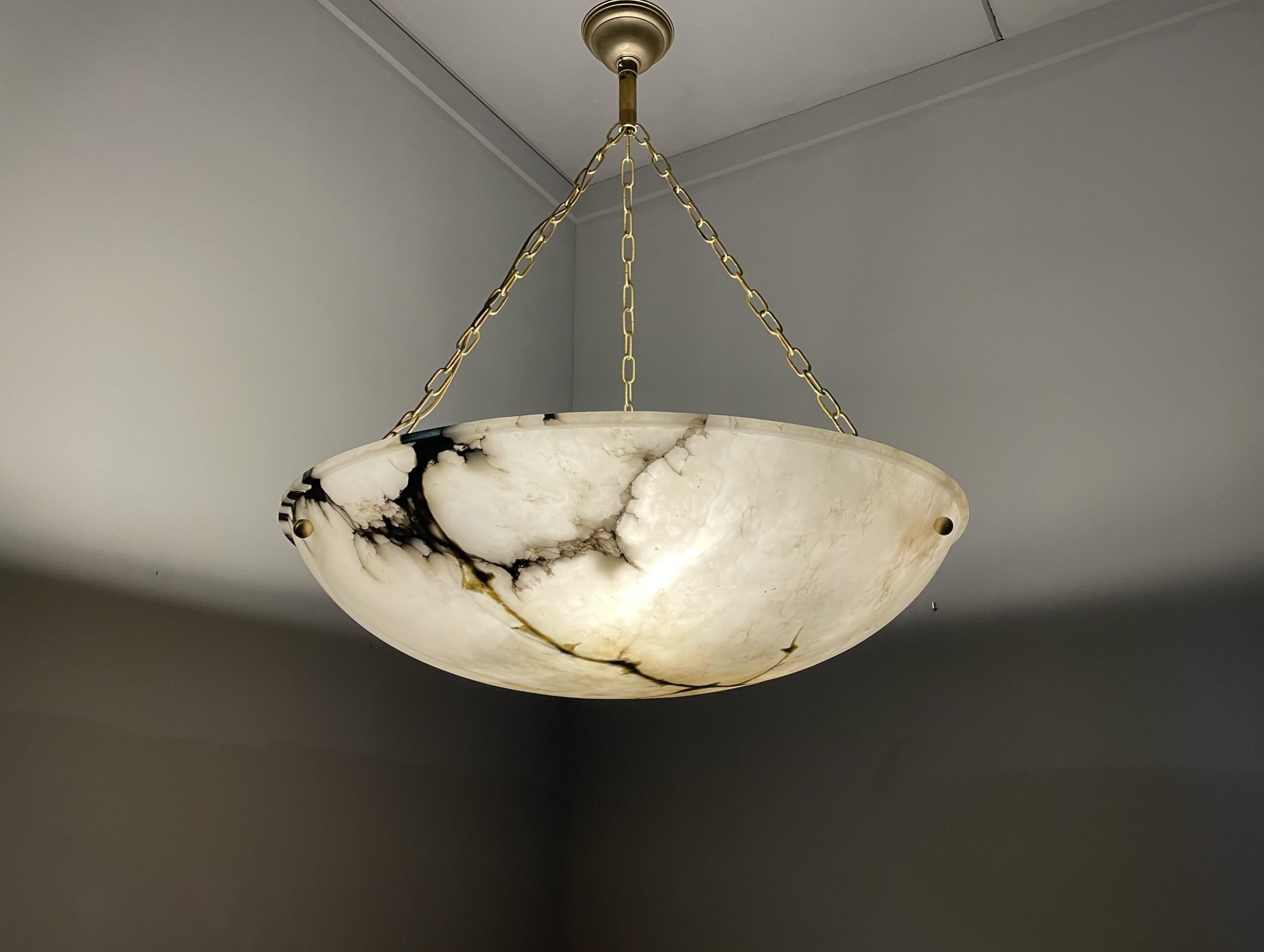 Largest, single alabaster shade chandelier ever.

Over the years we have offered and sold some of the best alabaster chandeliers, but never before were we able to purchase a single alabaster shade chandelier this size. Finding an antique alabaster