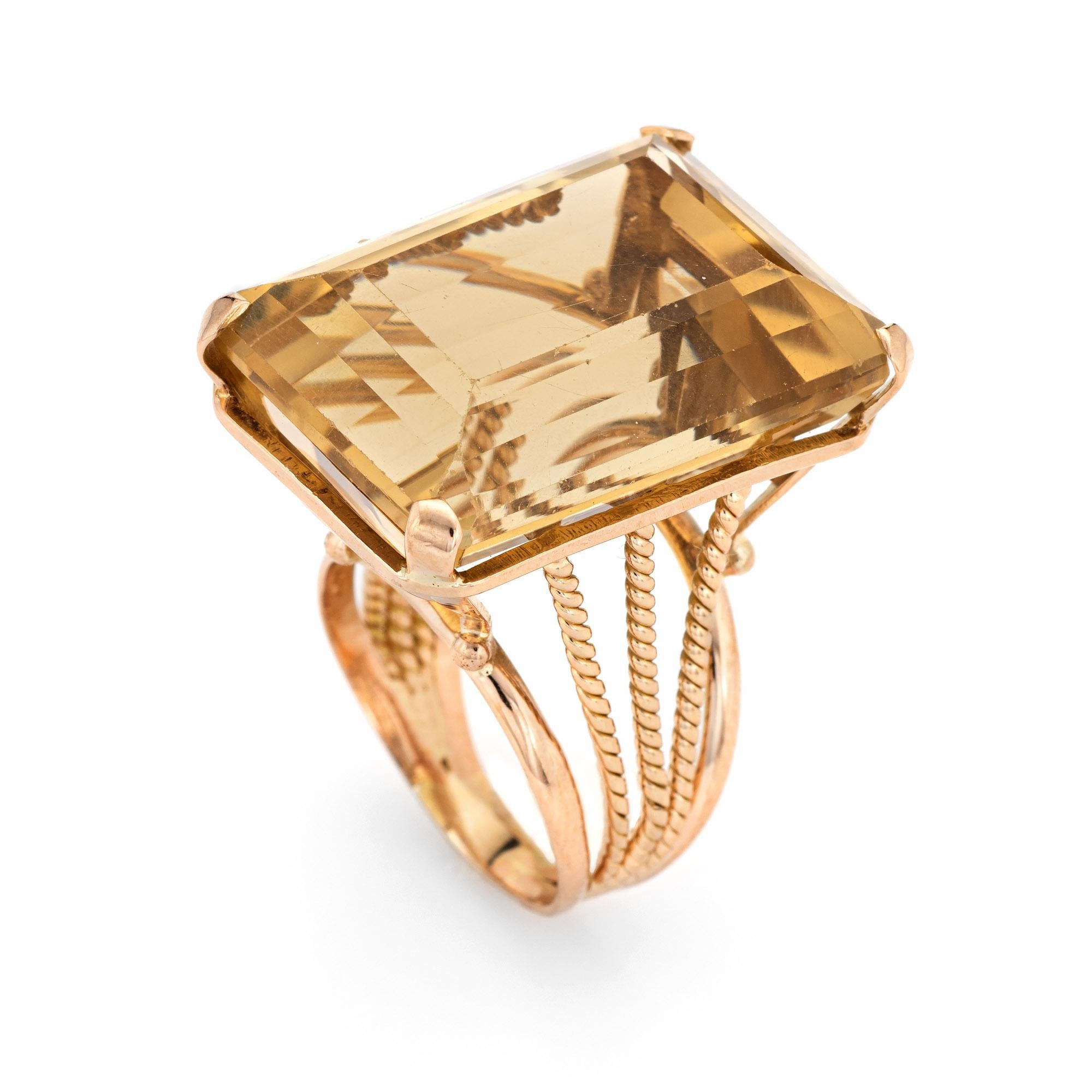 Stylish large vintage citrine ring (circa 1960s) crafted in 14 karat yellow gold. 

Emerald cut citrine measures 25mm x 19mm (estimated at 35 carats). The citrine is in good condition with a few light surface abrasions visible under a 10x loupe).